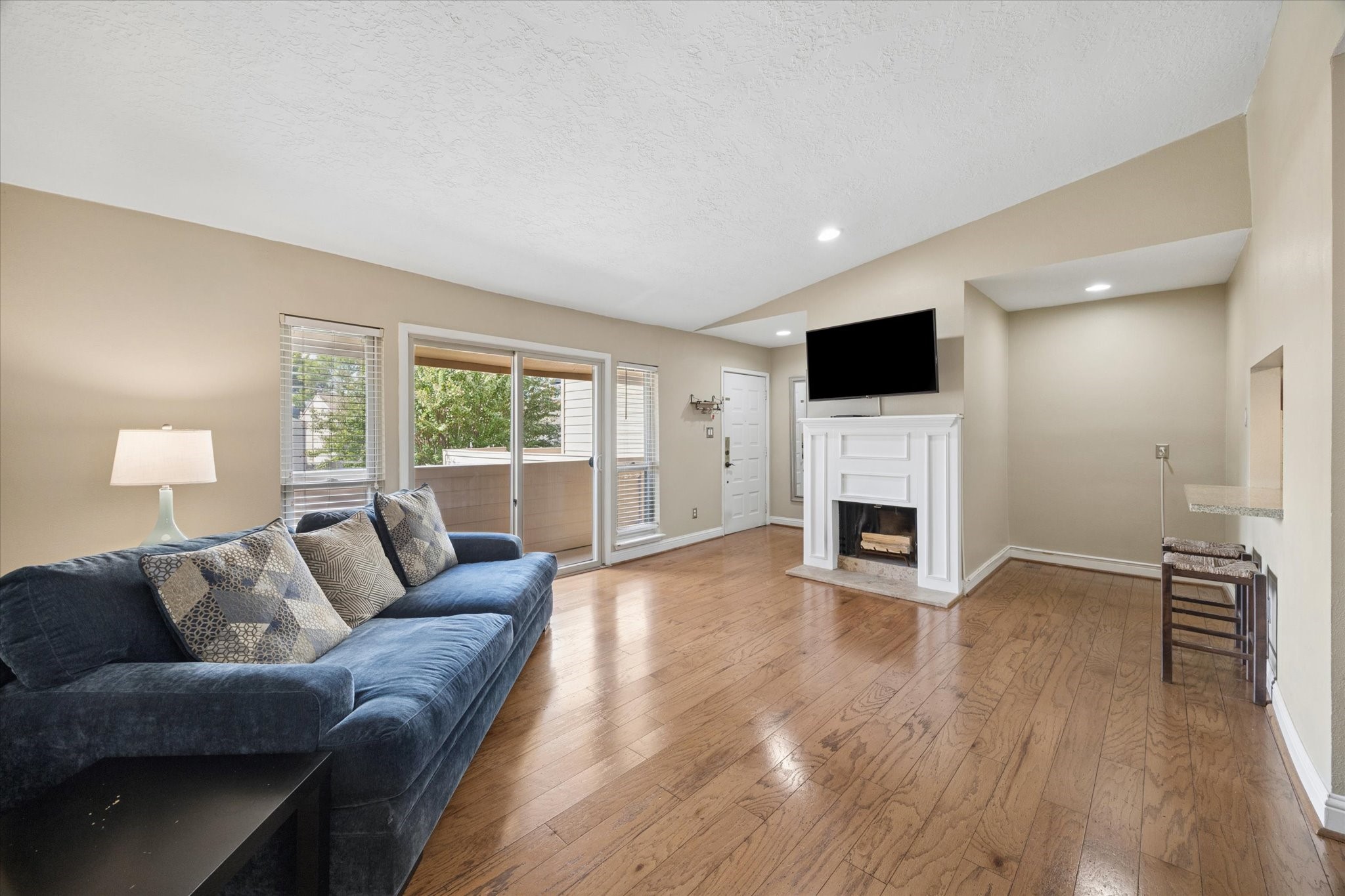 Bright, open living area with warm hardwood floors, neutral finishes, abundant natural light, and a seamless flow into the adjoining dining and kitchen spaces. Bright, open living area with warm hardwood floors, neutral finishes, abundant natural light, and a seamless flow into the adjoining dining and kitchen spaces.
