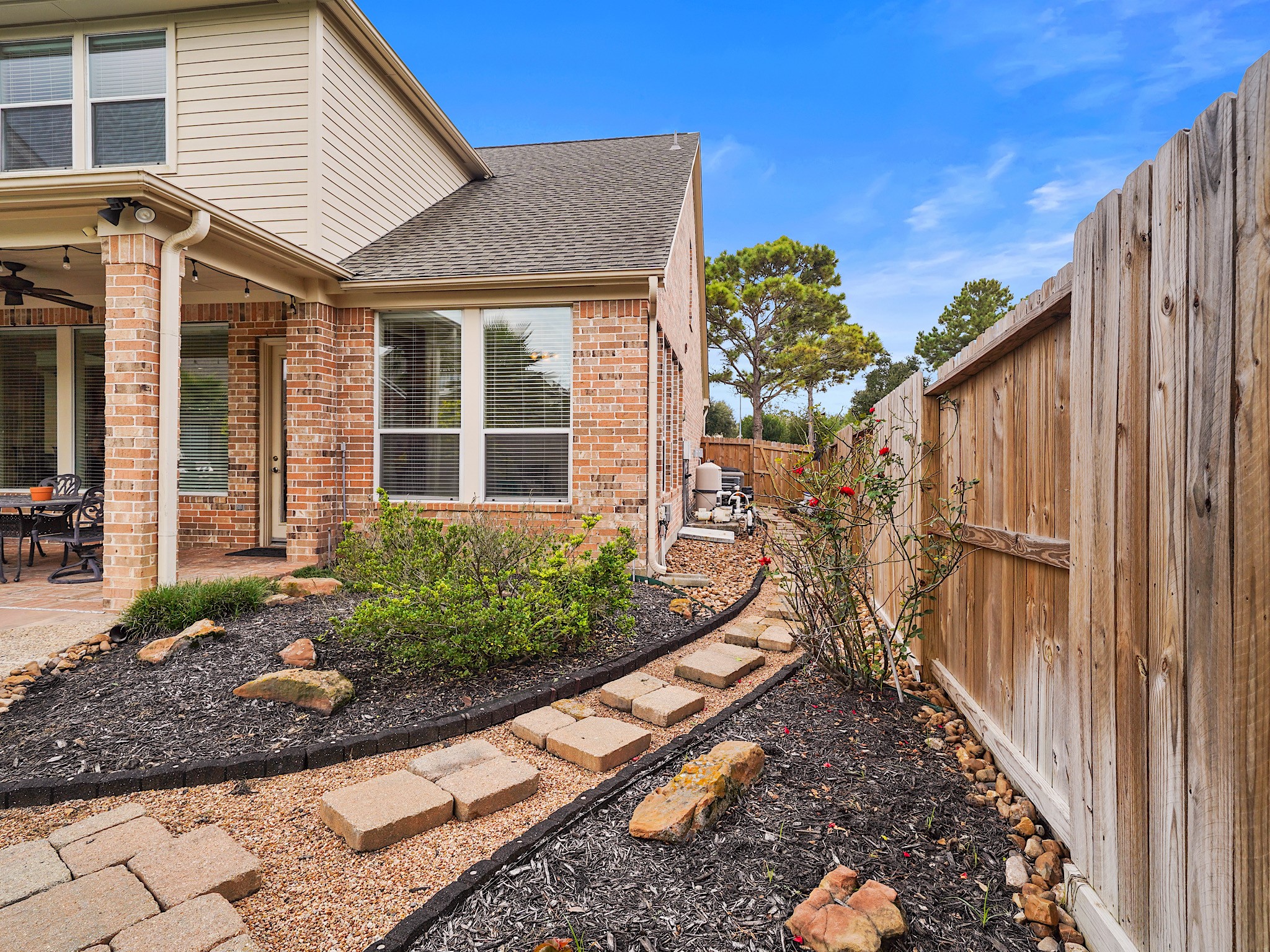 A thoughtfully landscaped side passage offers practical access around the home while maintaining a polished exterior.