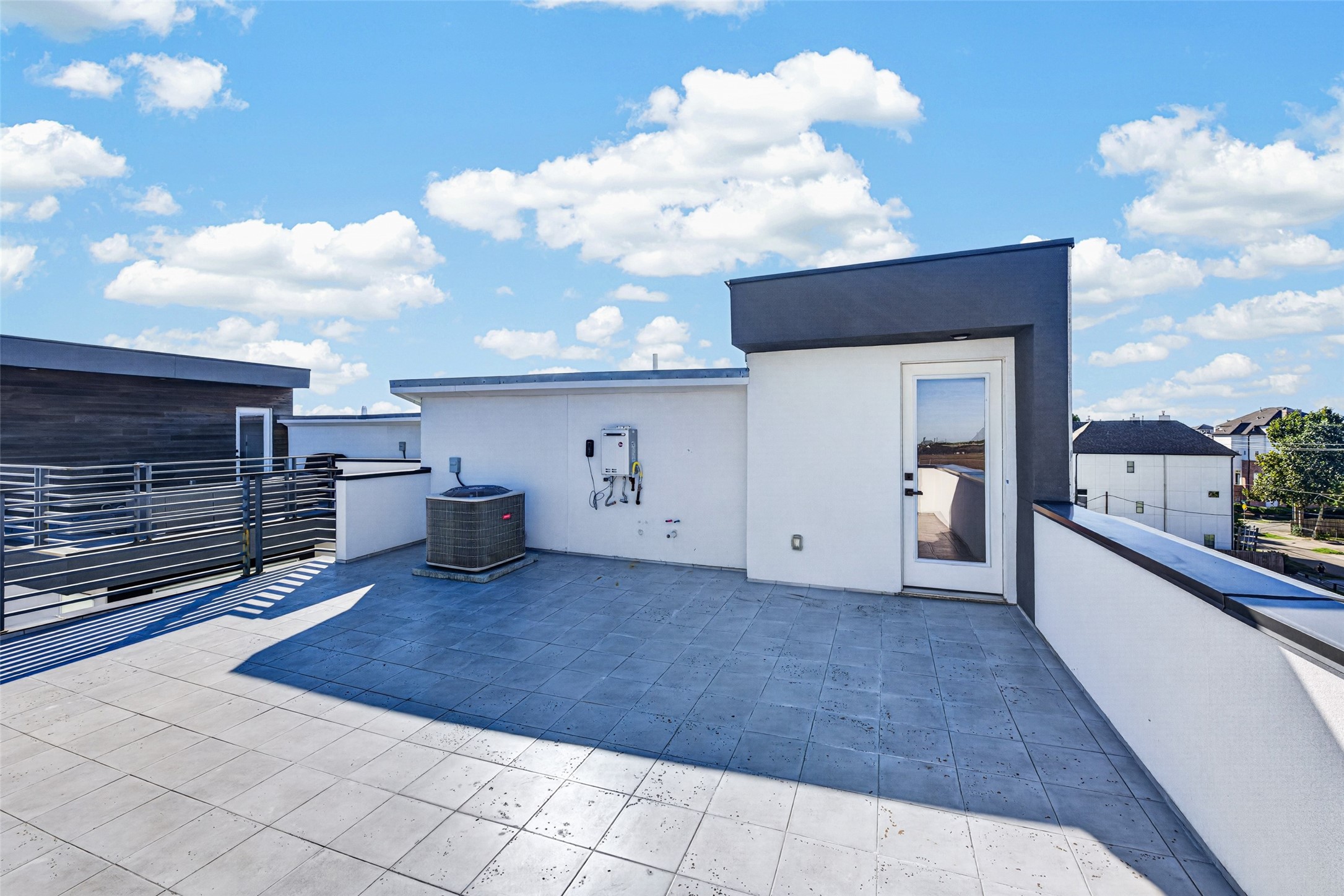 Spacious rooftop terrace offering paved tile flooring and panoramic views, perfect for outdoor entertaining.
