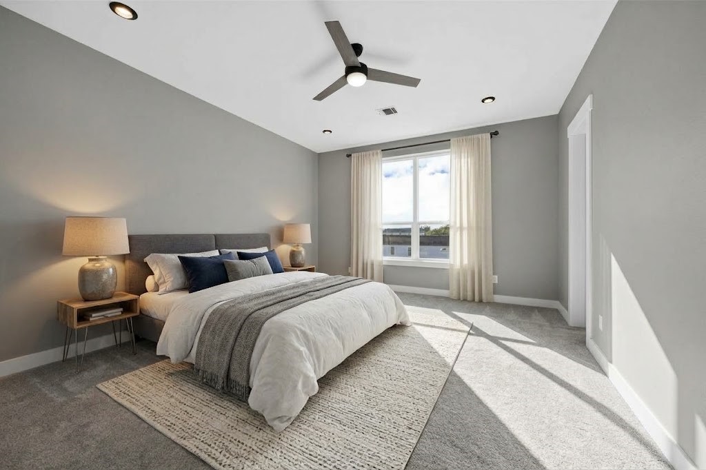 Cozy third-floor bedroom offering plush neutral carpeting, stylish ceiling fan, and generous closet storage spaceideal for family members or guests.