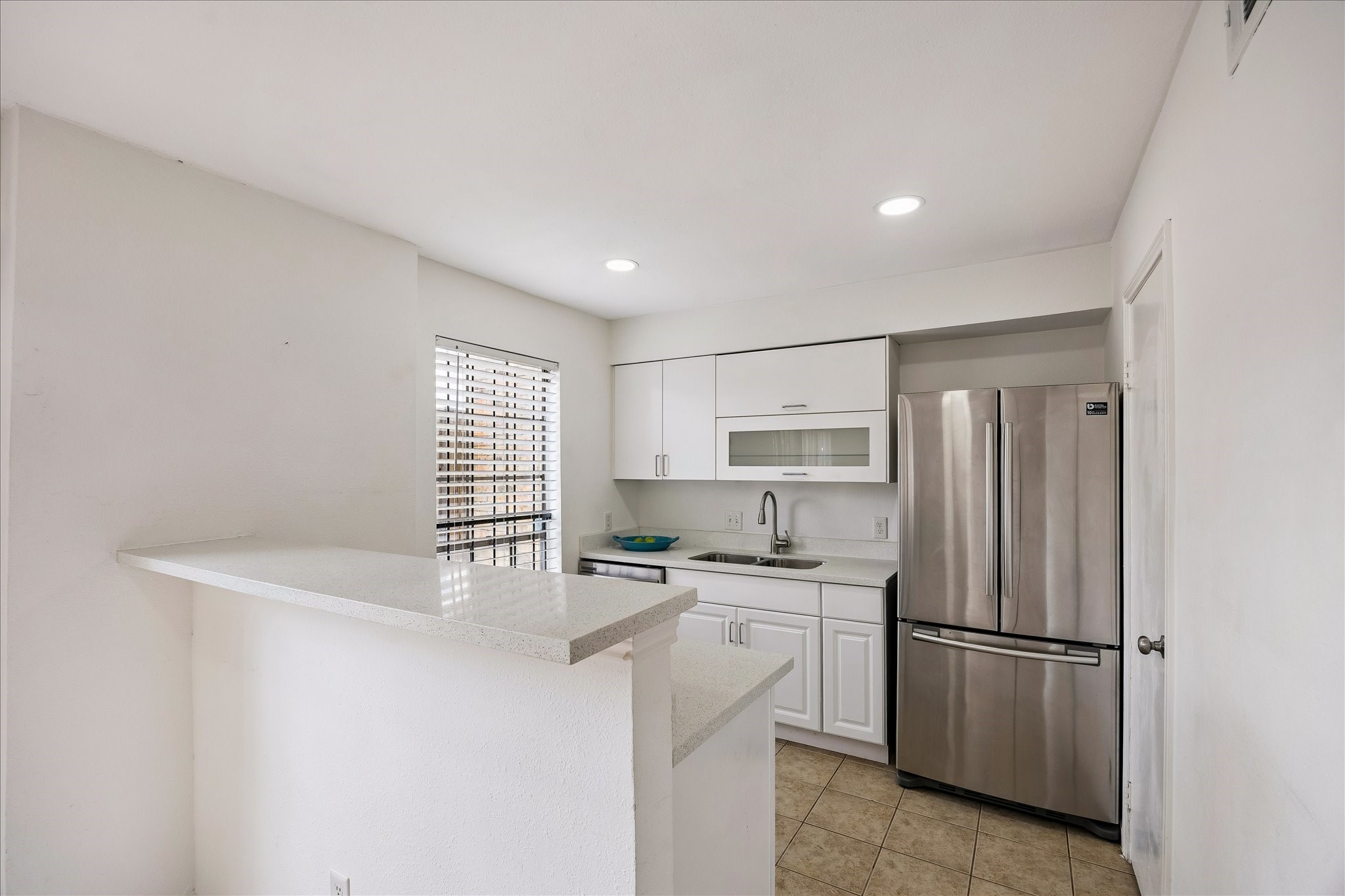 Nice glass front cabinets, stainless dishwasher and lovely tiling clean clean.