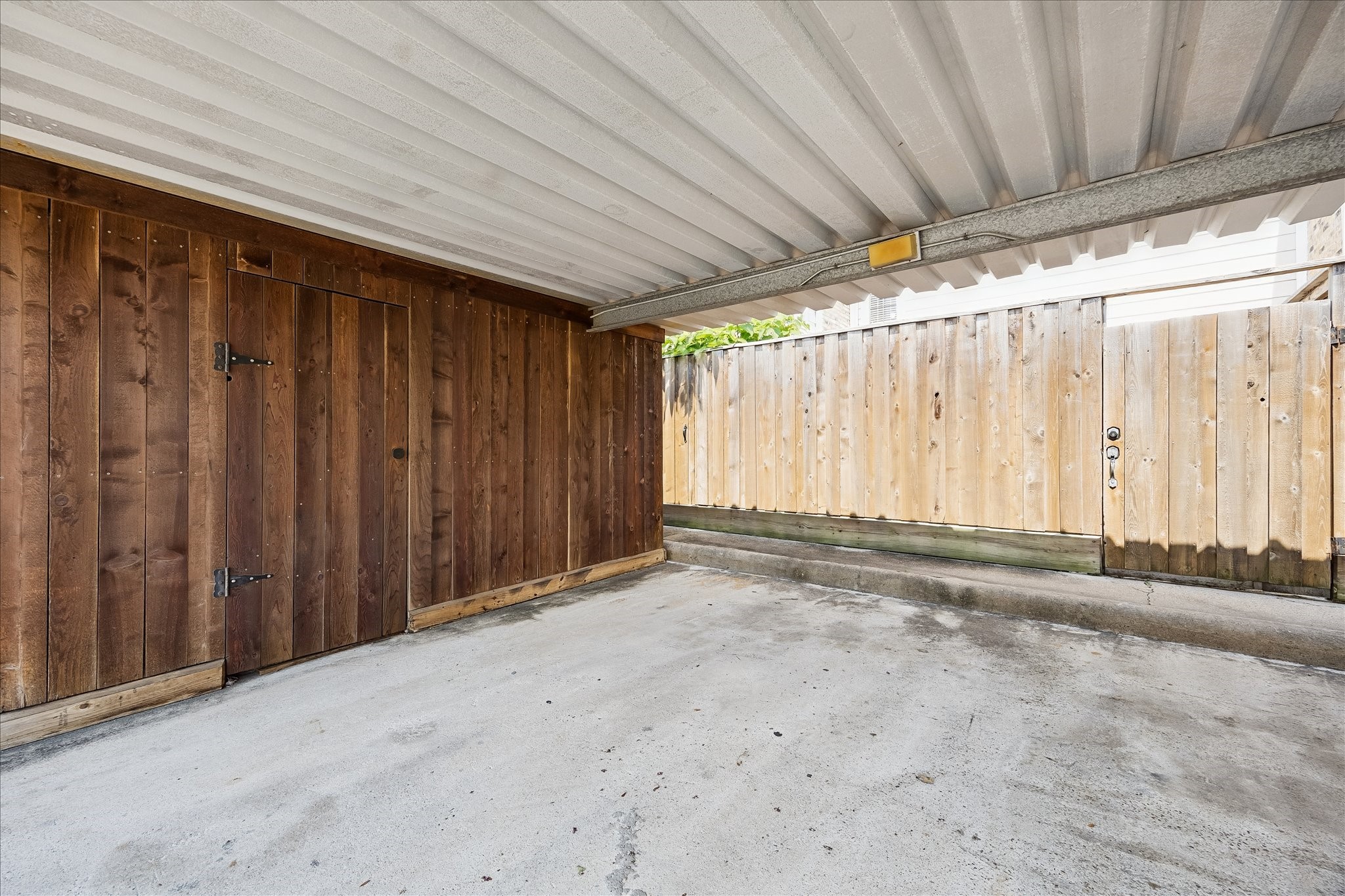 Your double carport is covered even has aa storage room