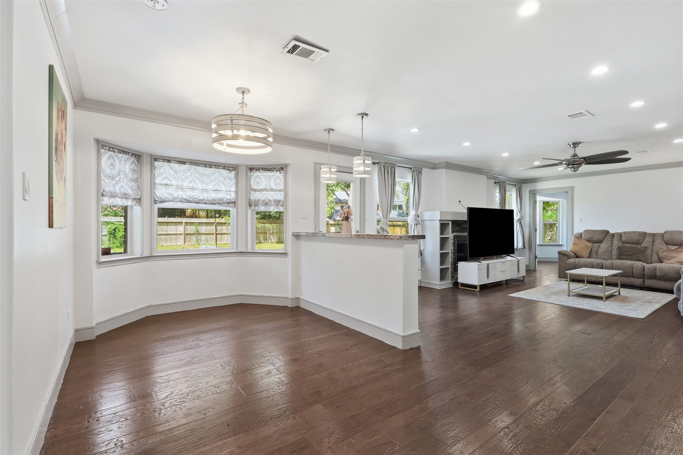 Open-concept living and breakfast area with hardwood floors, abundant natural light, and a seamless flow for everyday living.