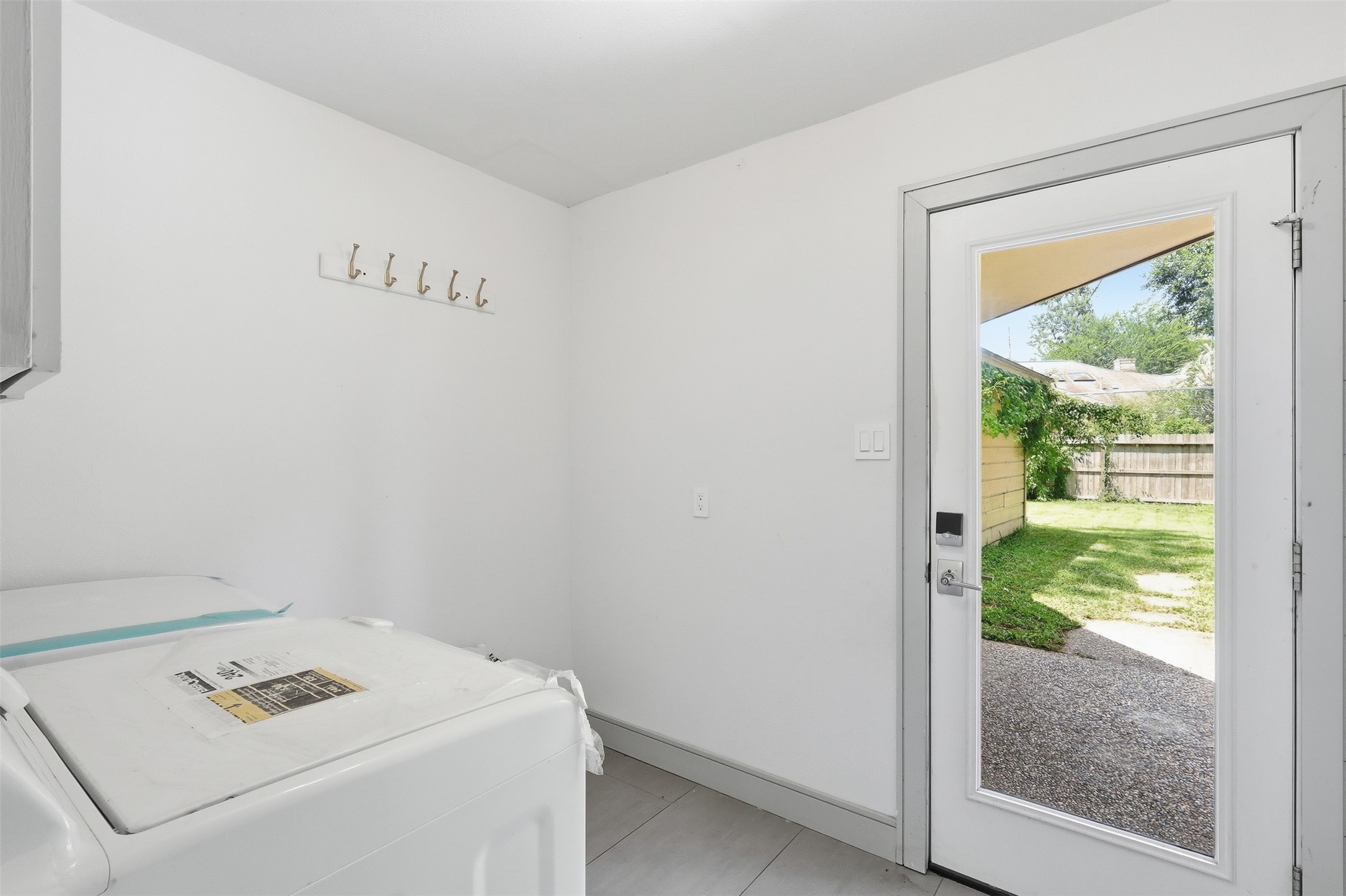 Convenient laundry room with direct access to the backyard.
