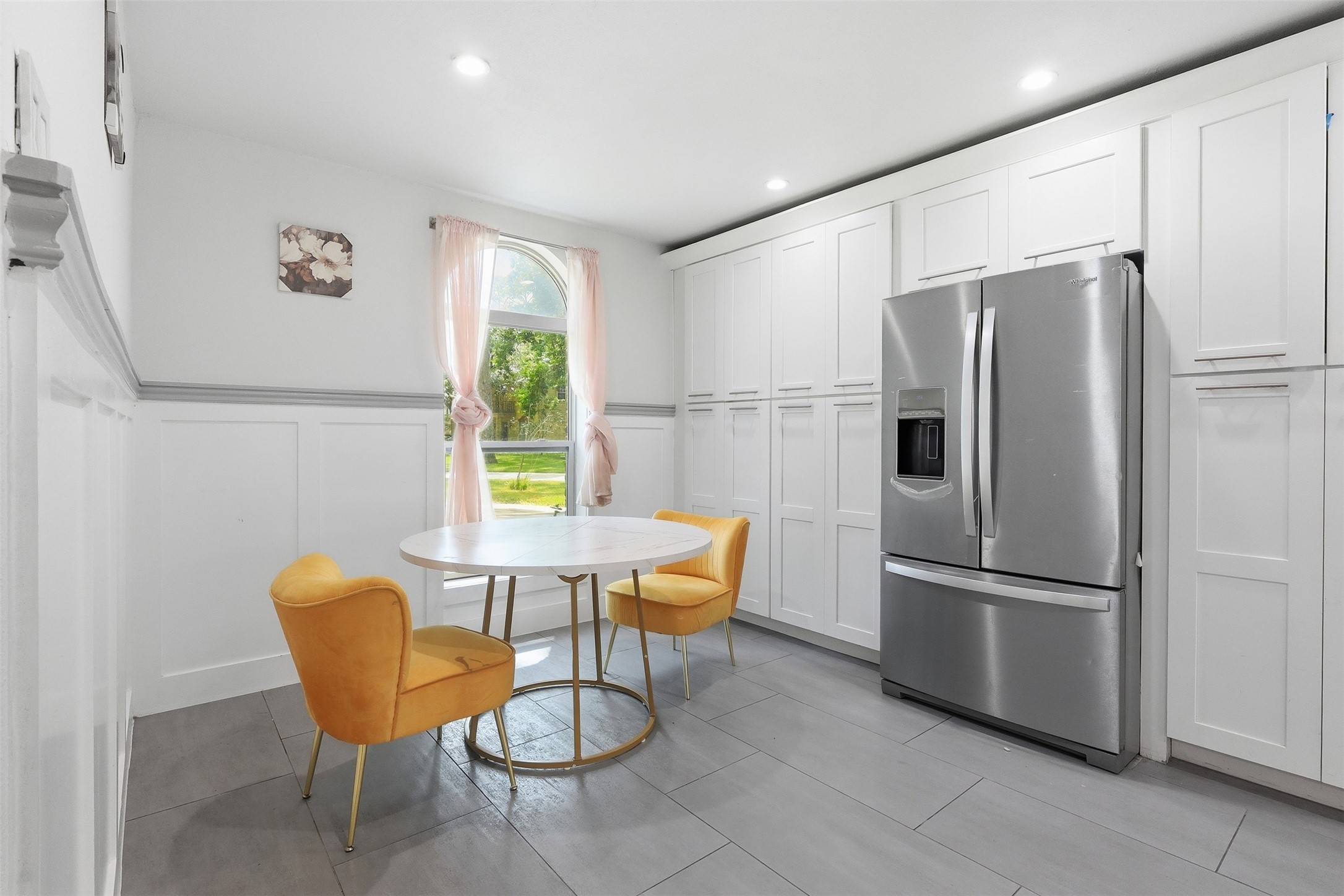 Bright breakfast area with extensive built-in cabinetry, offering incredible storage and charming architectural detail.