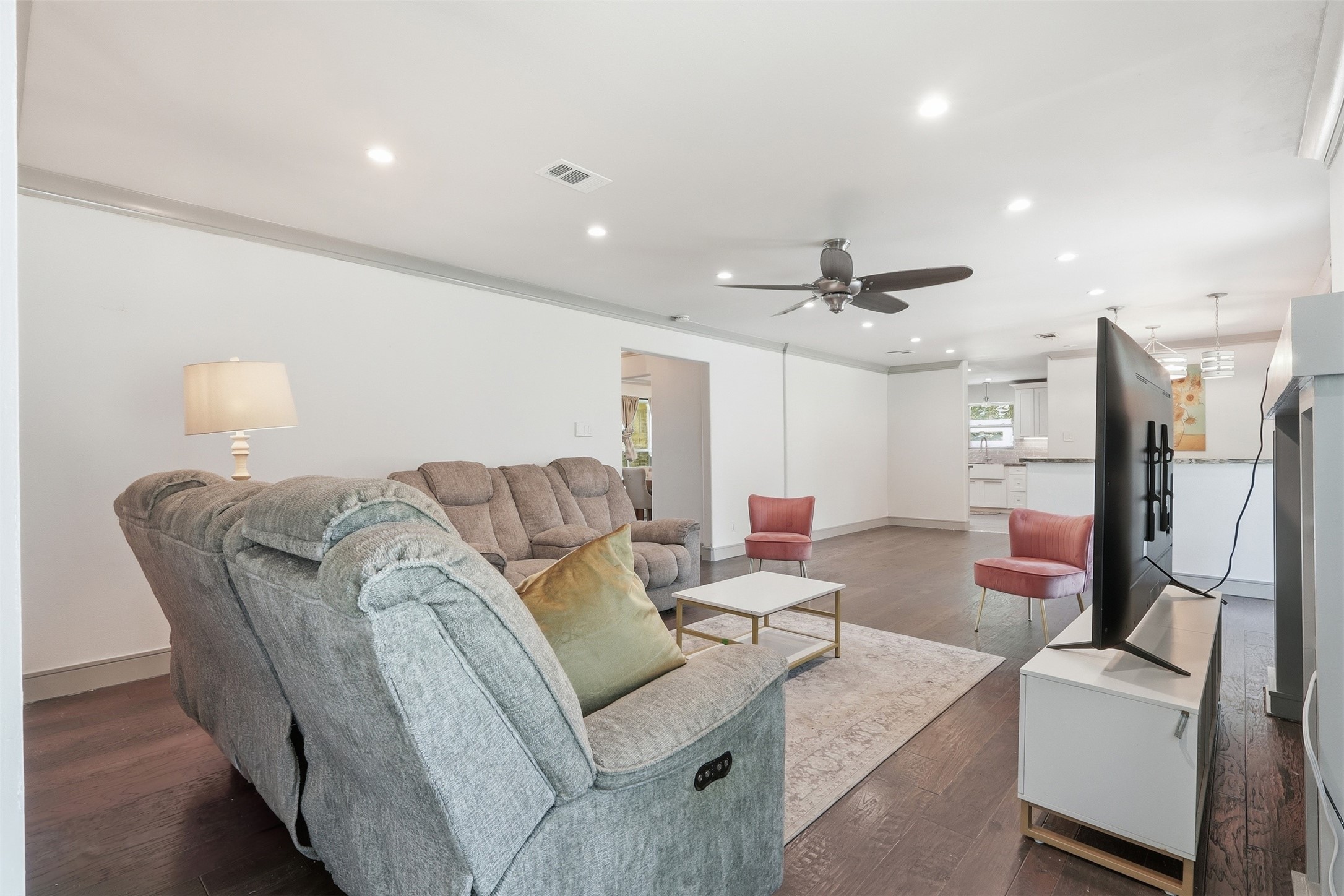 Expansive living room with hardwood floors and an open flow into the kitchenideal for everyday living and entertaining.