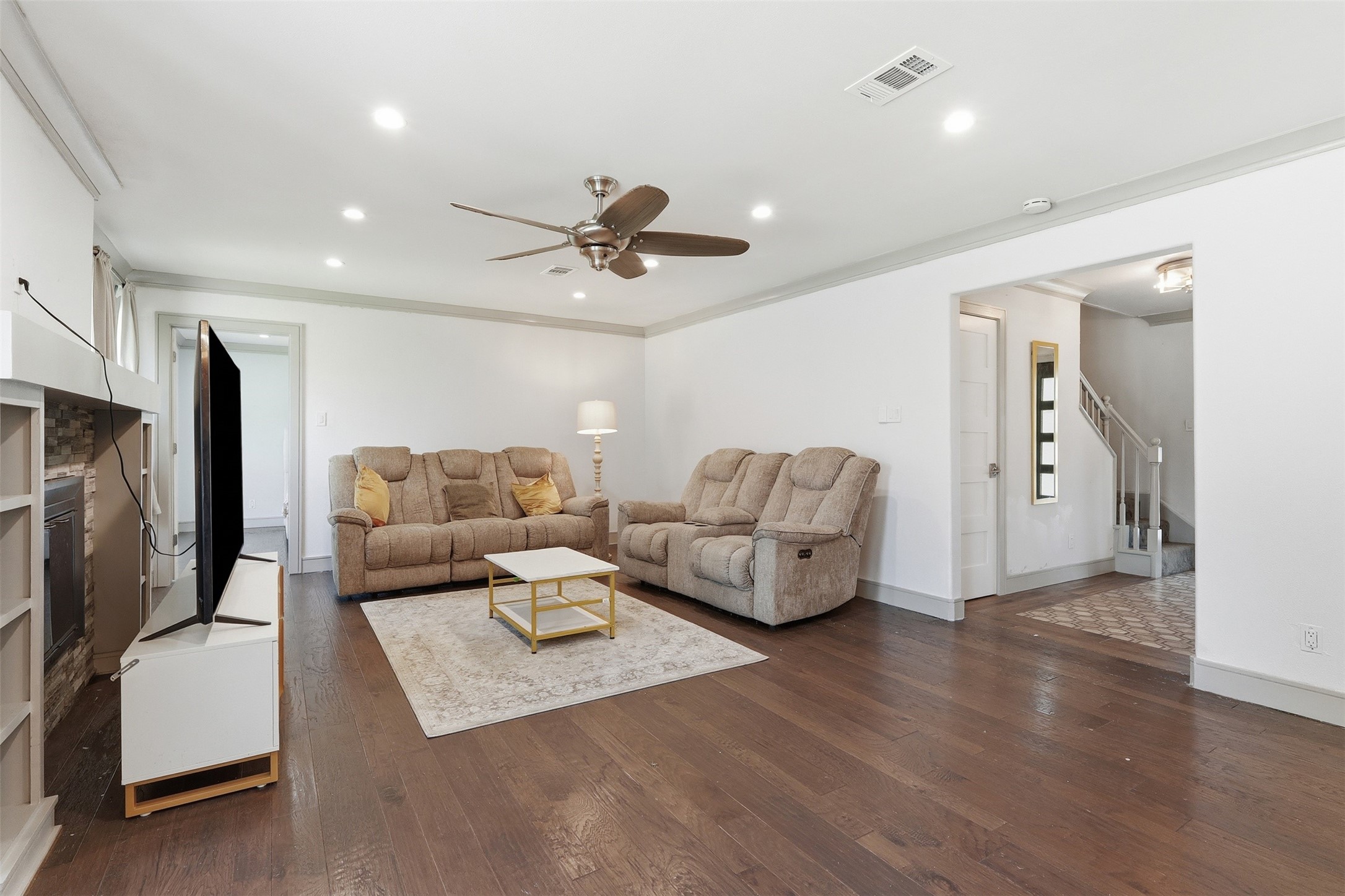 Generously sized living room with hardwood floors, recessed lighting, and plenty of space to gather and unwind.