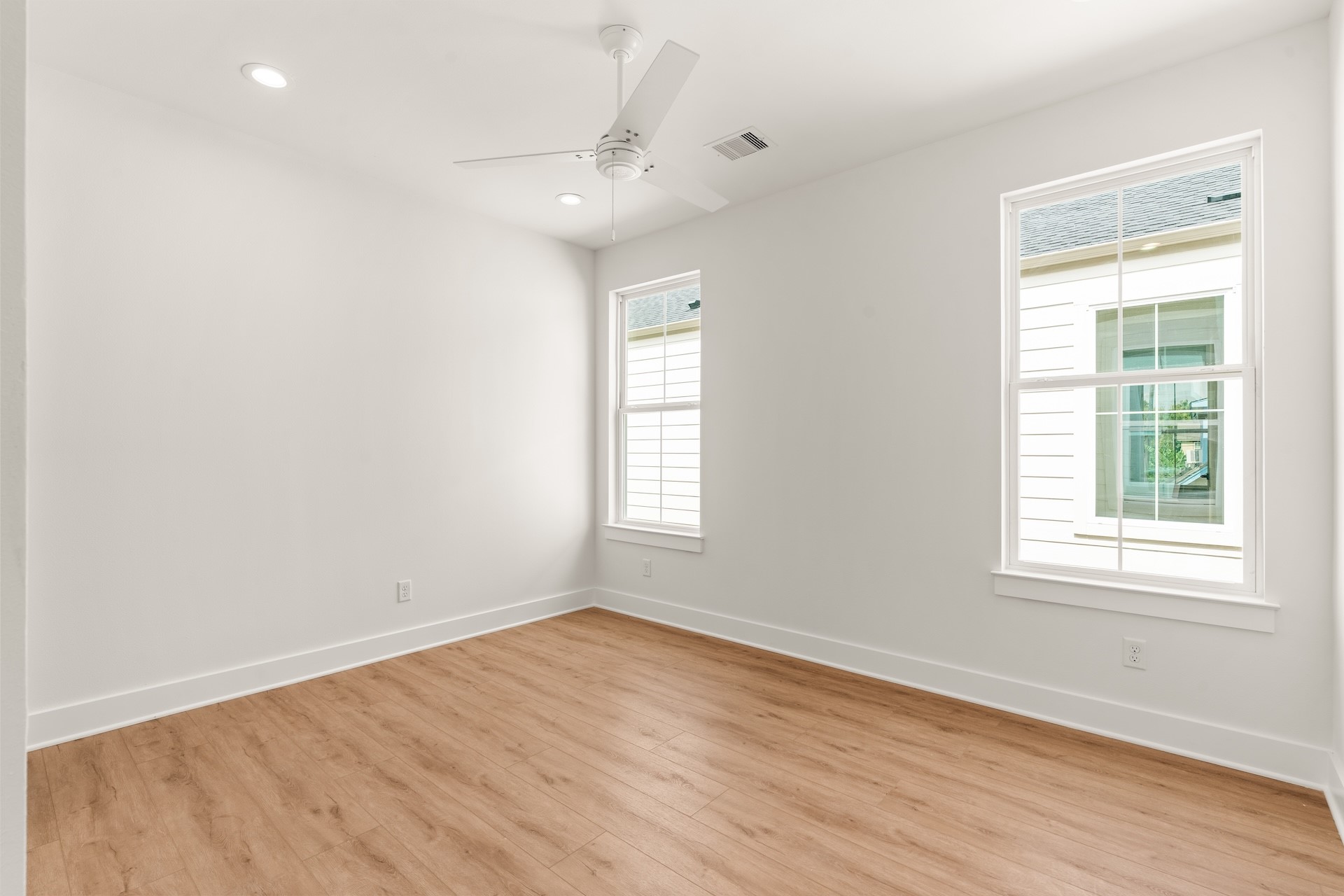 Spacious secondary bedroom designed with generous closet space and ceiling fan.