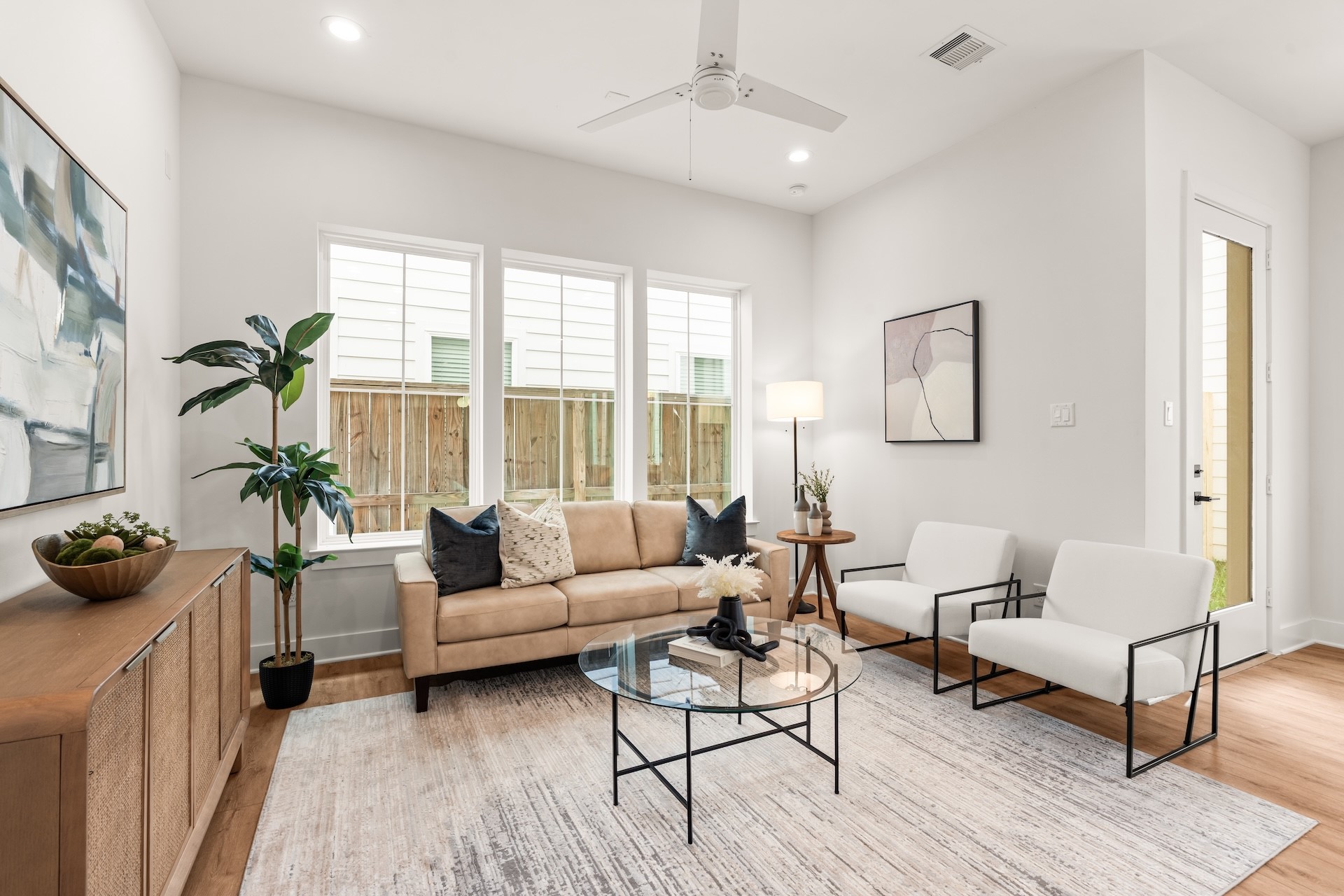 Open-concept layout offering effortless flow between the kitchen, central dining, and main living areas.