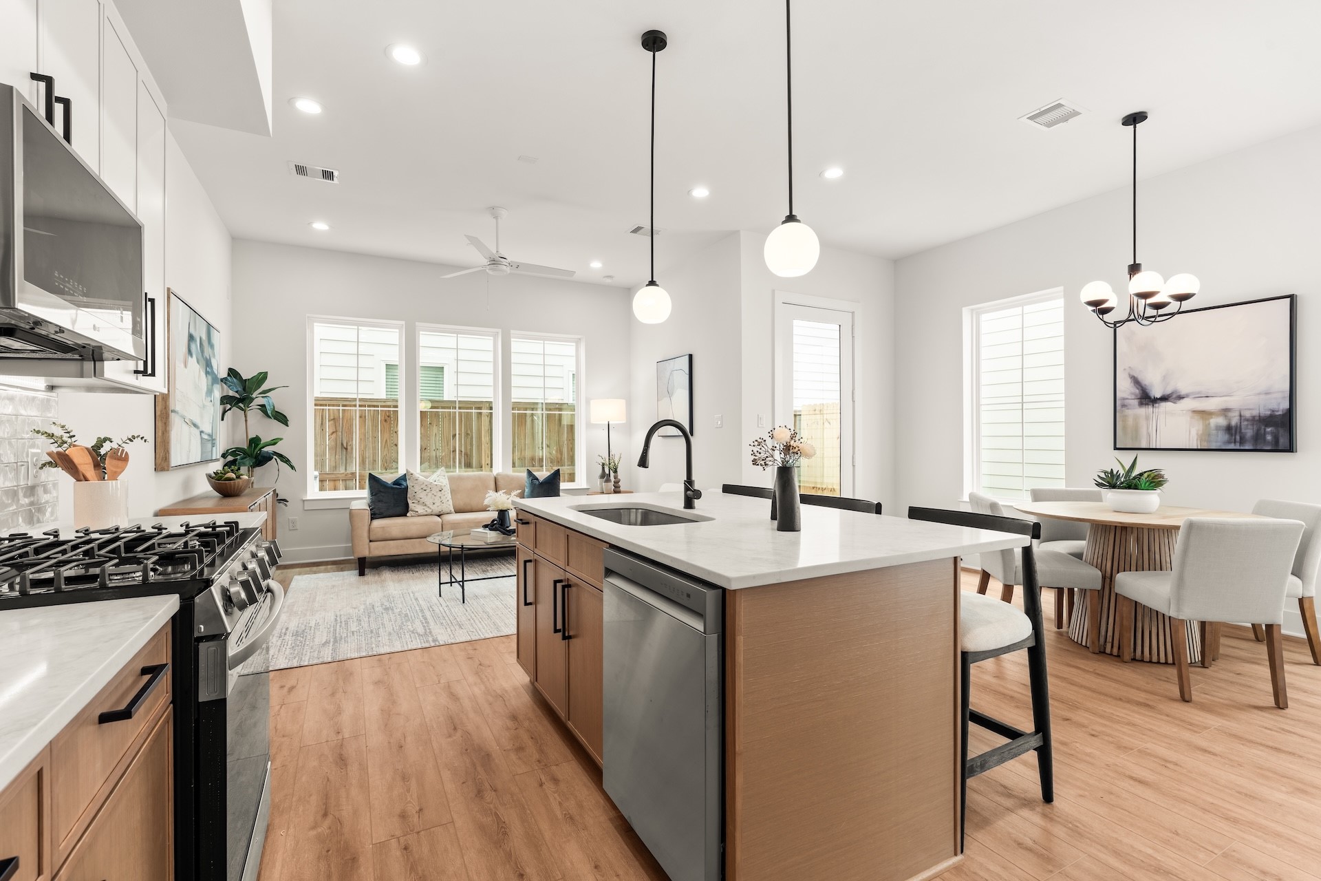 Fluid living space combining kitchen, dining, and patio access for easy indoor-outdoor entertaining.