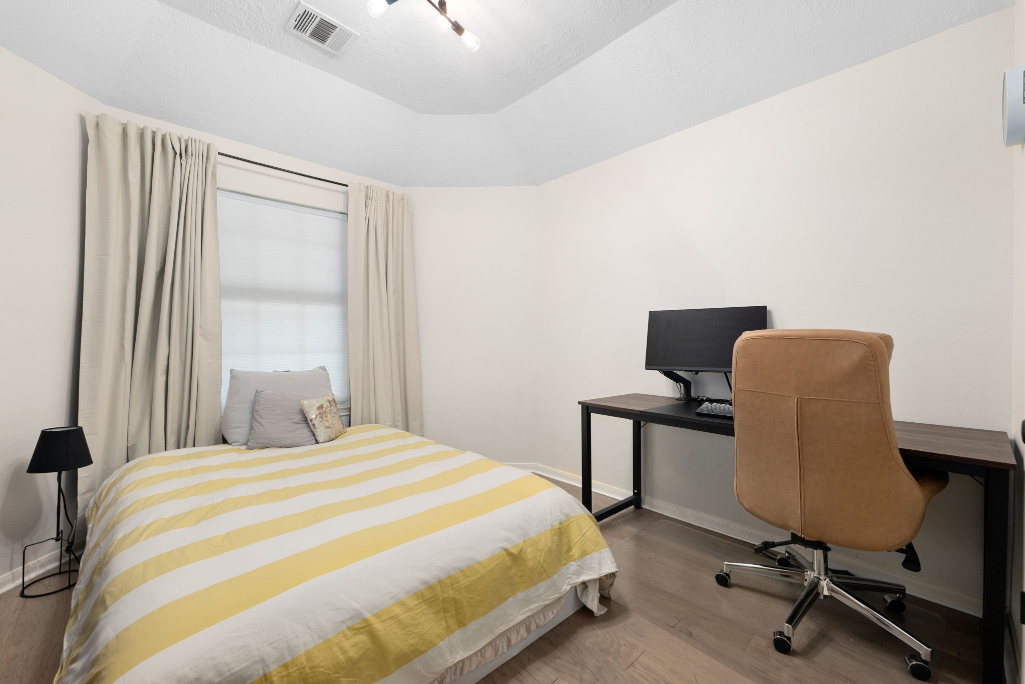 A cozy secondary bedroom is perfect for home office.