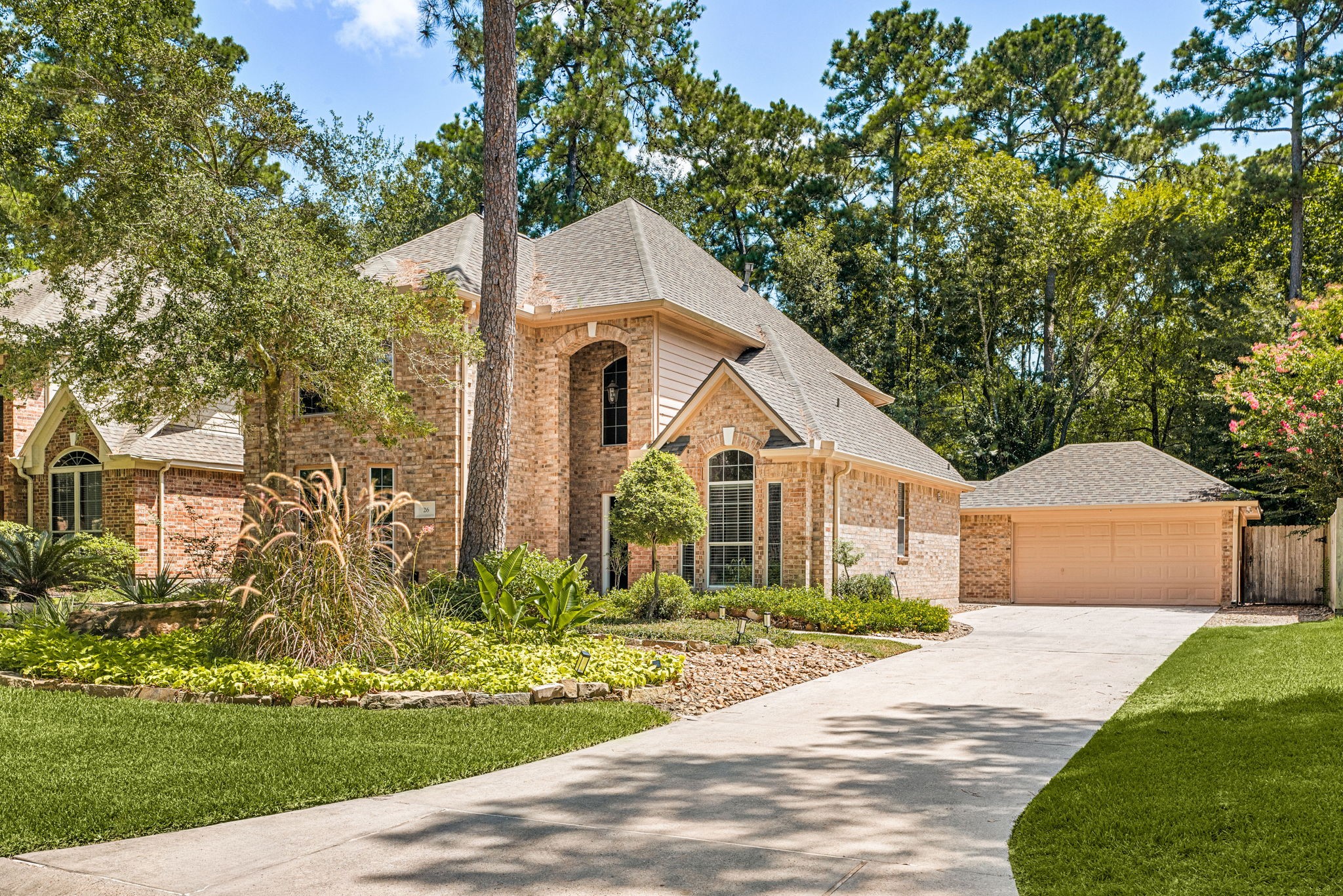 A spacious driveway leading to detached garage.