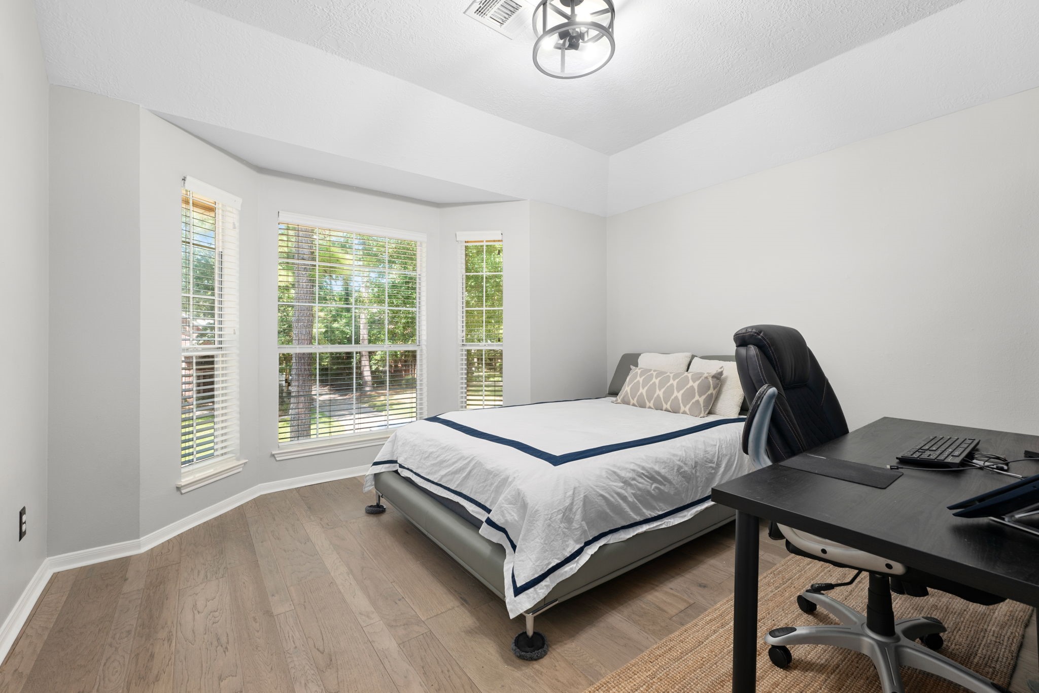 Bright and inviting secondary bedroom feature a large bay window and ample apace for rest.