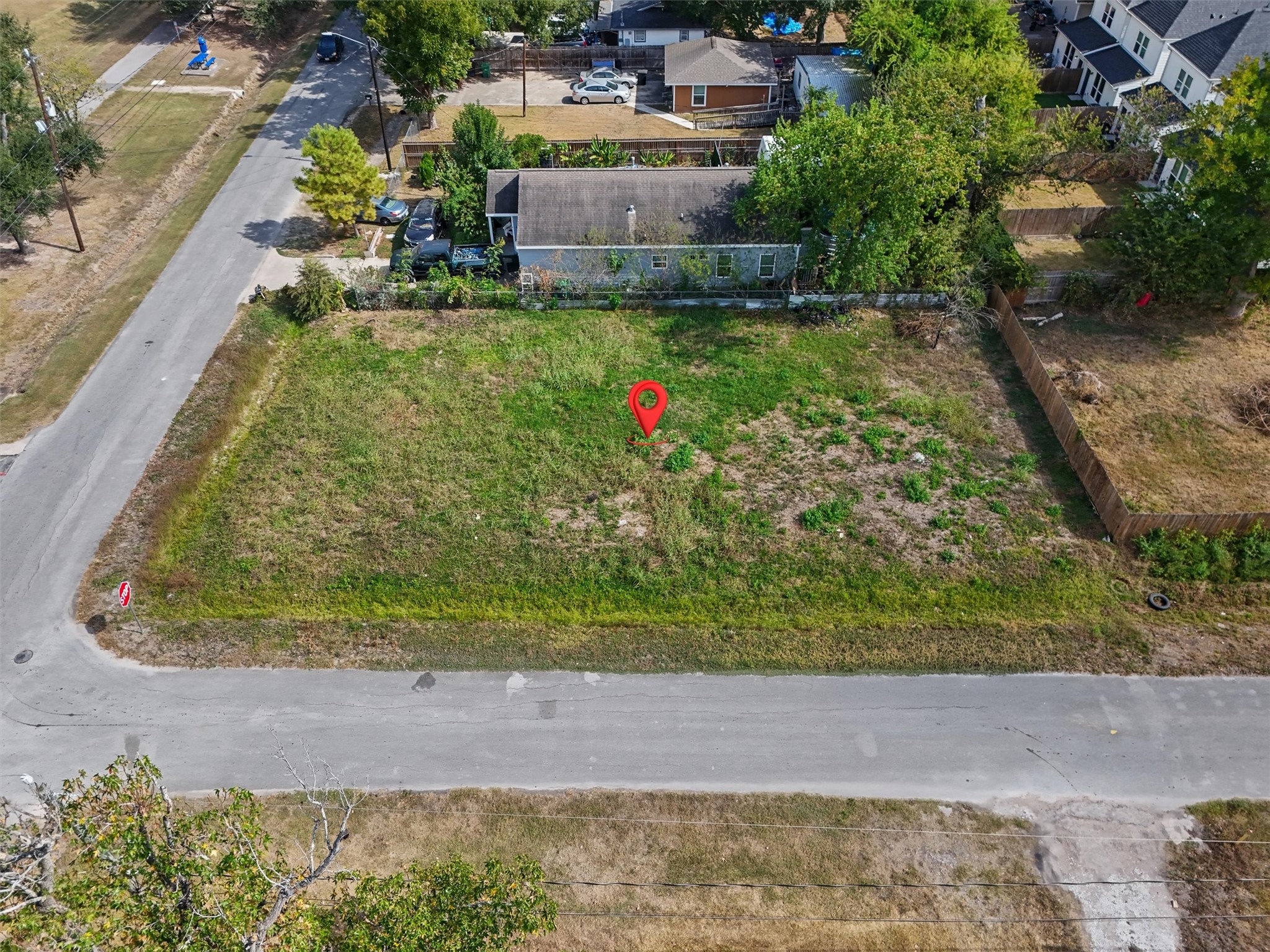 Imagine the possibilities! Build your dream home on this spacious corner lot in an established residential neighborhood. With road frontage on two sides, this property offers flexibility for your future home design, outdoor living space, and landscaping. The red marker highlights this inviting homesite, ready for you to bring your vision to life!