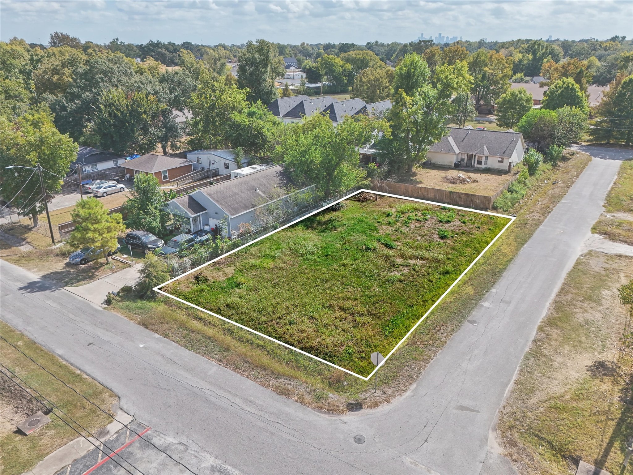 Excellent corner lot offering road frontage on two sides and convenient access from the surrounding neighborhood! The white outline highlights the property's approximate boundaries, showcasing its spacious layout and potential for future development. Situated in an established residential community, this property presents a great opportunity to build your dream home or explore investment possibilities.
