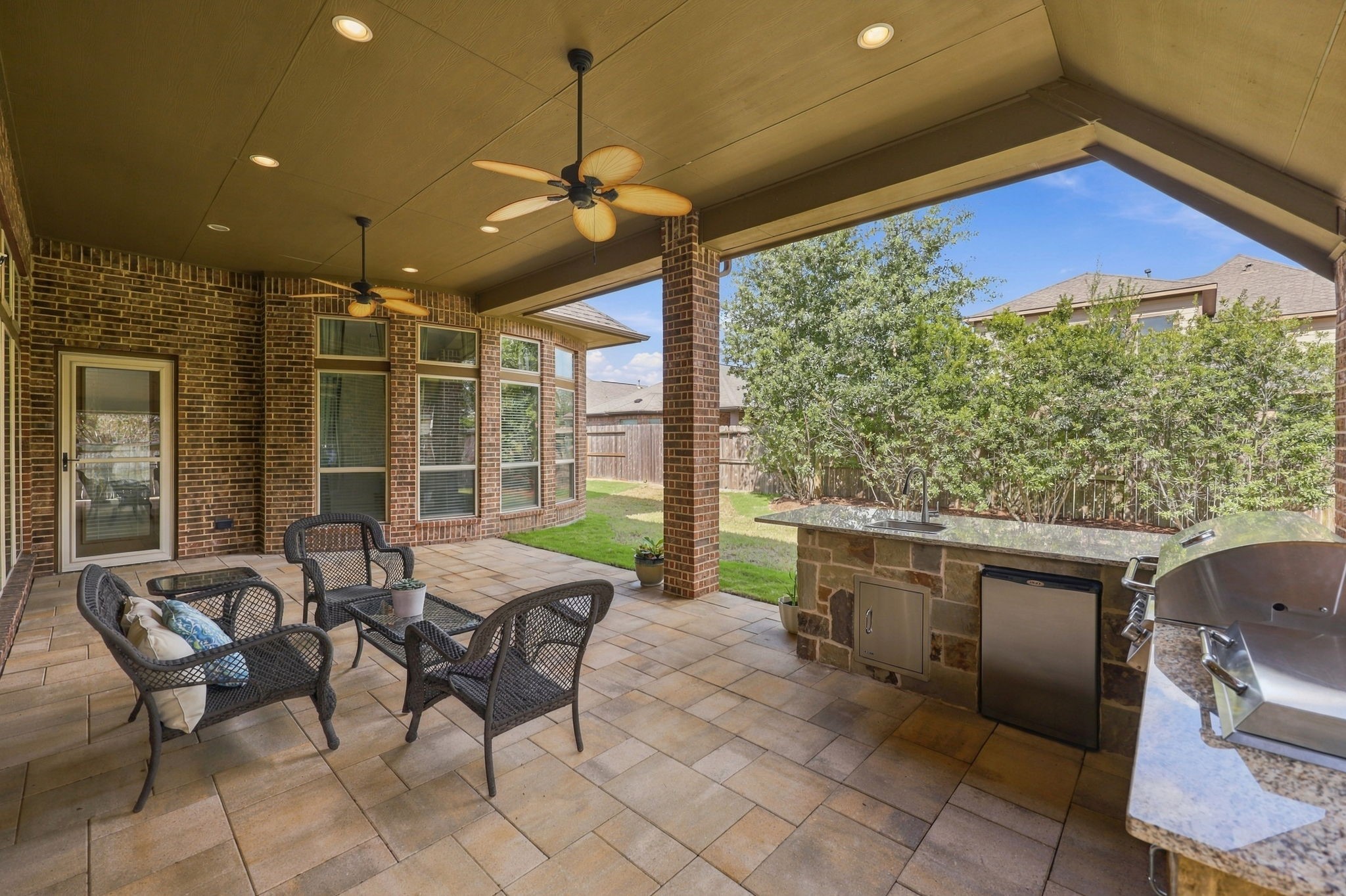 This view looks out toward the Backyard, where mature landscaping provides added privacy and creates a peaceful outdoor setting. The low-maintenance yard is easy to care for, allowing you to spend more time relaxing and enjoying your outdoor living space.