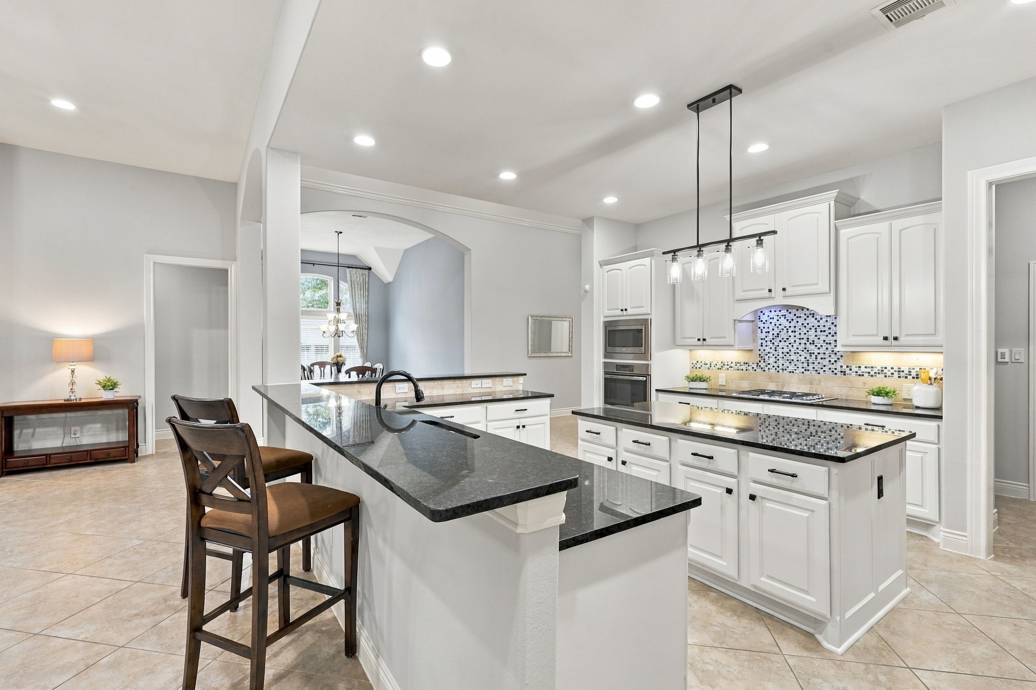 This view offers a closer look at the Breakfast Bar and highlights the additional seating options this thoughtfully designed floor plan provides, creating a welcoming space for casual dining and gathering with family and friends.