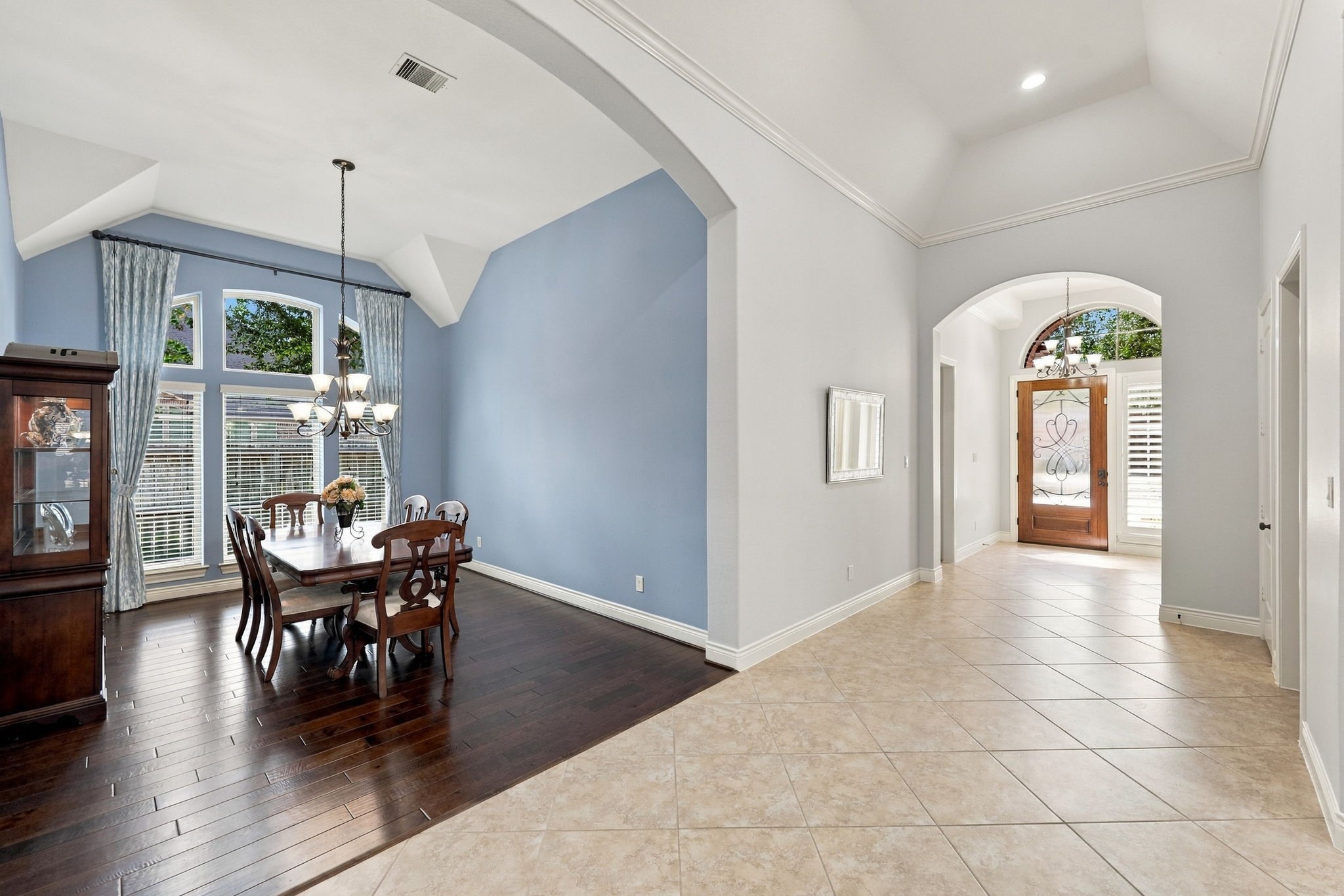 Looking back toward the front entrance, you'll notice the beautiful wood door with glass inset, complemented by a transom window above and a sidelight window that allows natural light to flow into the Foyer. To the left, an inviting glimpse of the Formal Dining room adds to the home's elegant appeal. Looking back toward the front entrance, you'll notice the beautiful wood door with glass inset, complemented by a transom window above and a sidelight window that allows natural light to flow into the Foyer. To the left, an inviting glimpse of the Formal Dining room adds to the home's elegant appeal.