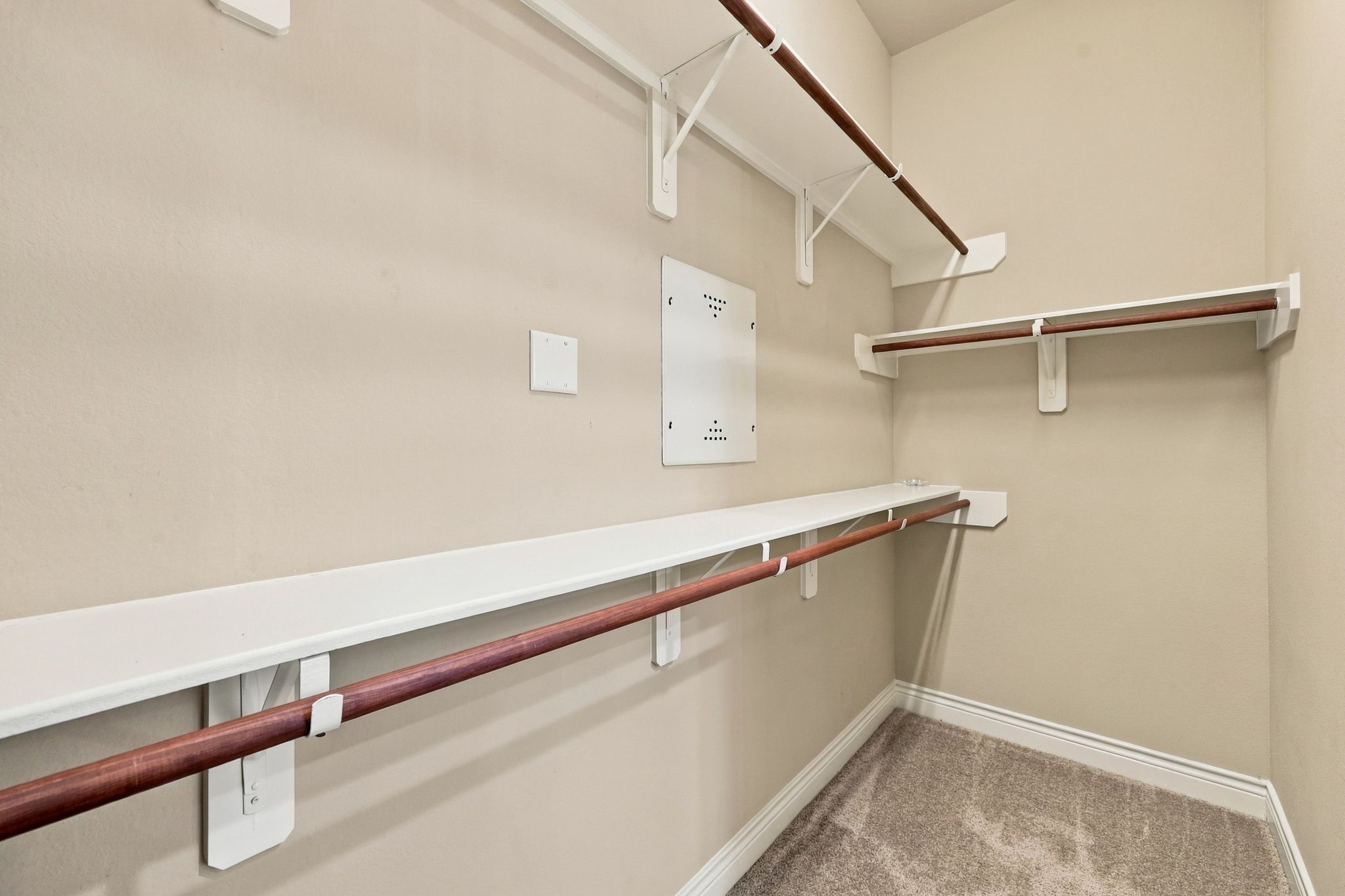 The Primary Bathroom offers two separate walk-in closets for added storage and organization. This spacious closet is the second of the two, providing ample room for clothing, shoes, and accessories.
