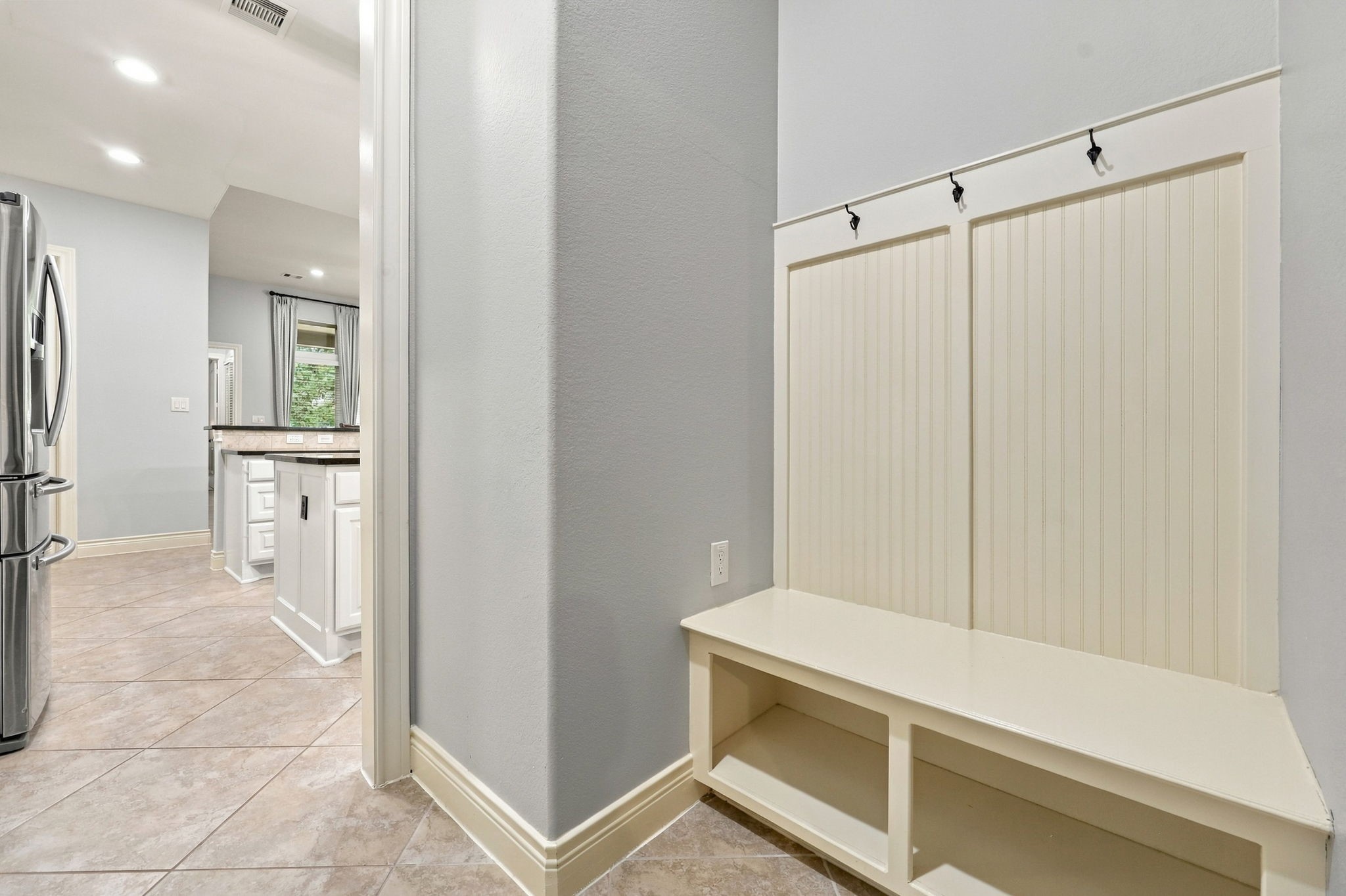 Another great feature of this home is the convenient Mud area located just inside the entrance from the 3-car tandem garage. This thoughtfully designed space includes hanging hooks for coats and bags, a built-in bench for sitting while removing shoes, and storage underneath to help keep everyday essentials organized and out of sight.