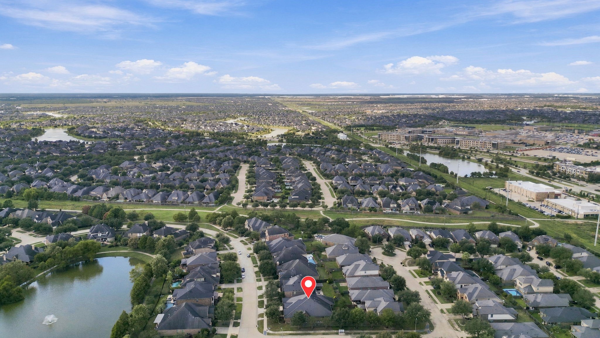 This aerial view, looking north, showcases the surrounding area and highlights the many lakes and walking trails throughout the Cross Creek Ranch community. The home's location is pinpointed for easy reference, giving you a better perspective of the neighborhood and its beautiful natural surroundings.
