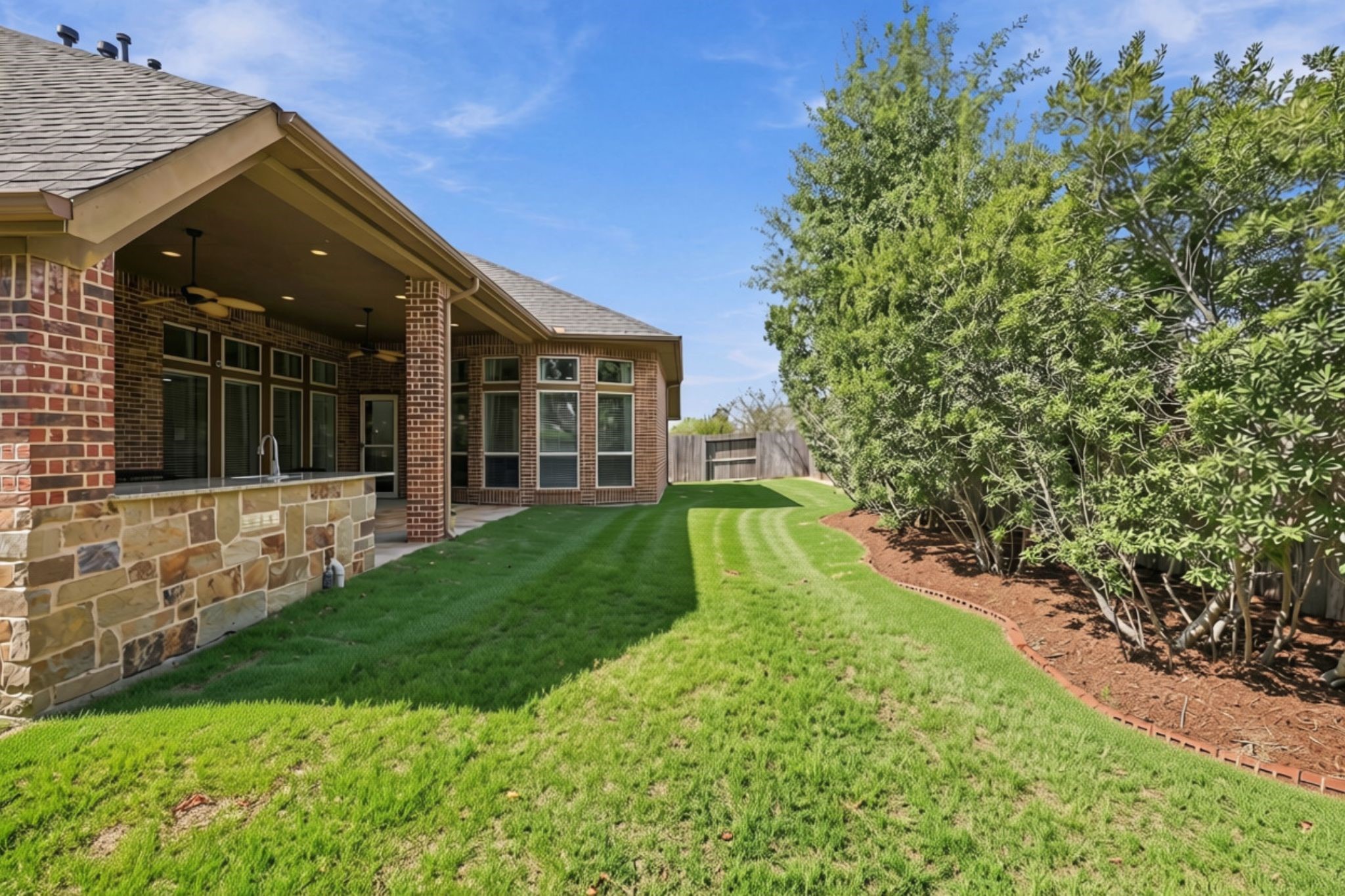 Looking down the length of the backyard, you'll appreciate the generous outdoor space with plenty of room for children to play, pets to roam, and family and friends to enjoy the outdoors.