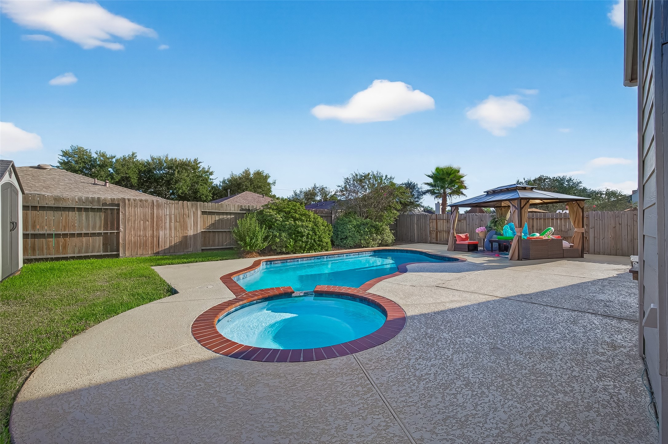 Well-maintained decking surrounds the pool.