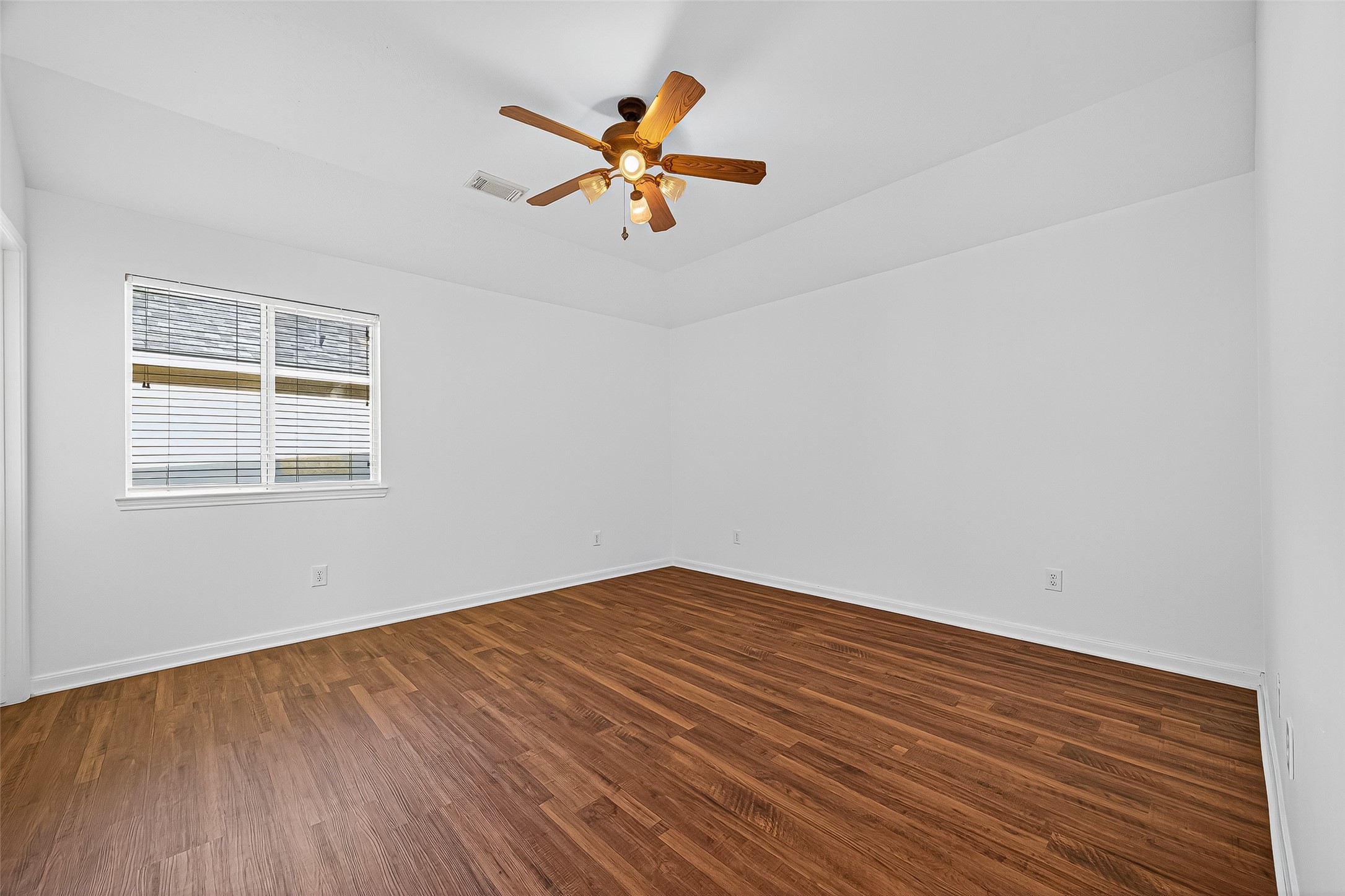 Bedroom 3 is light and bright with with neutral paint.