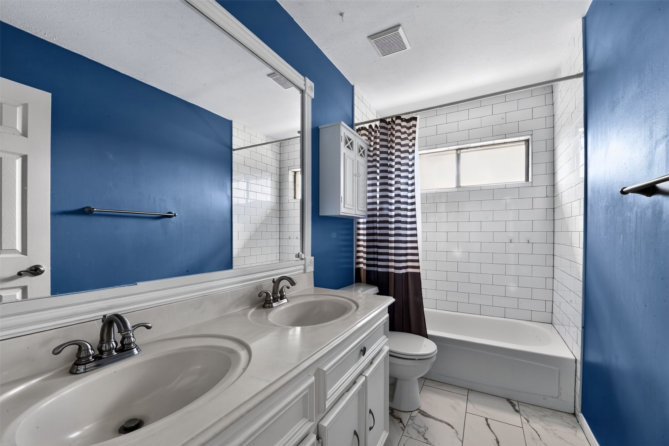 Full second bath upstairs is conveniently located between the bedrooms and boasts double sinks.
