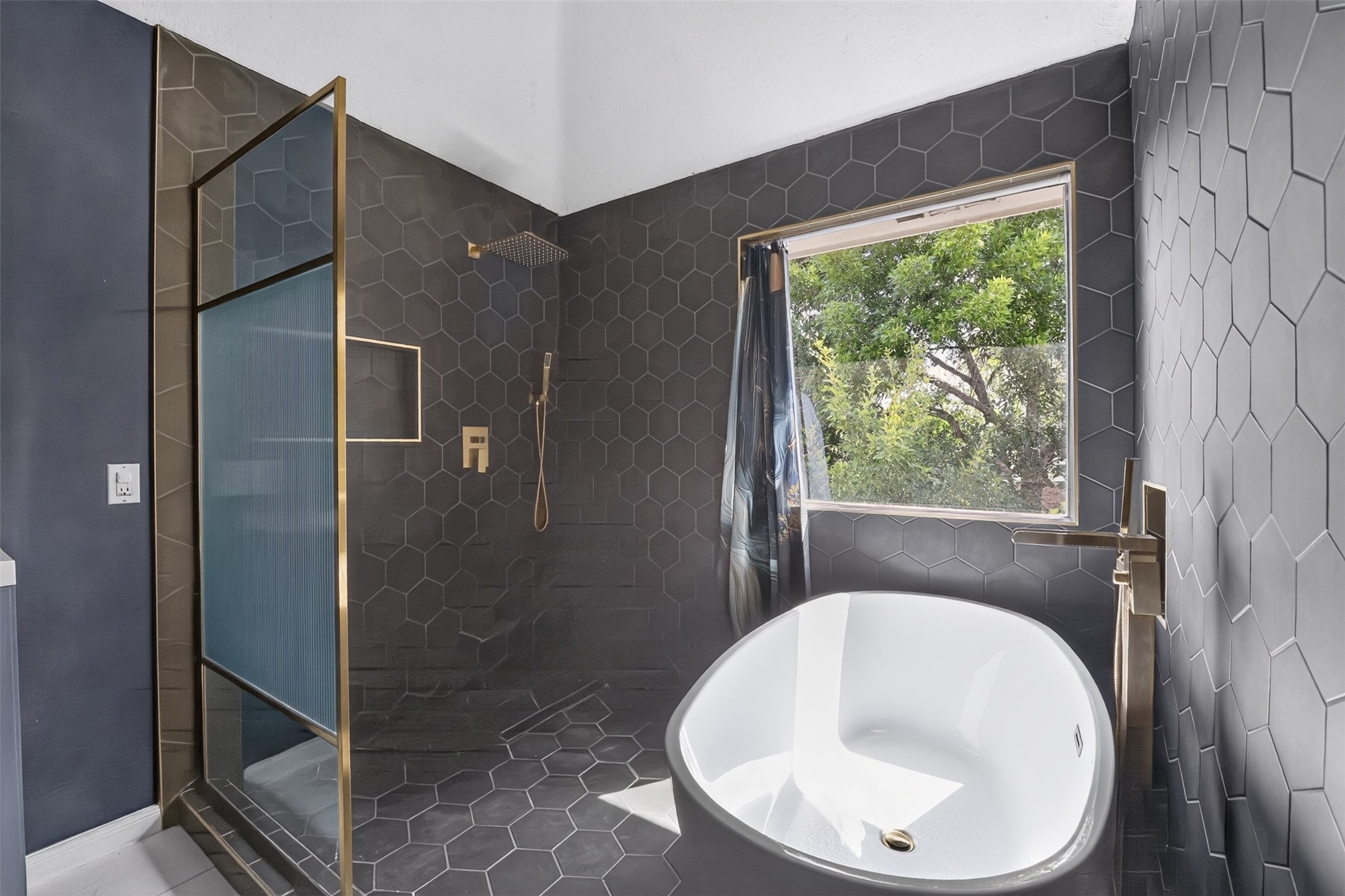Recently remodeled primary bath has soaking tub and large shower.