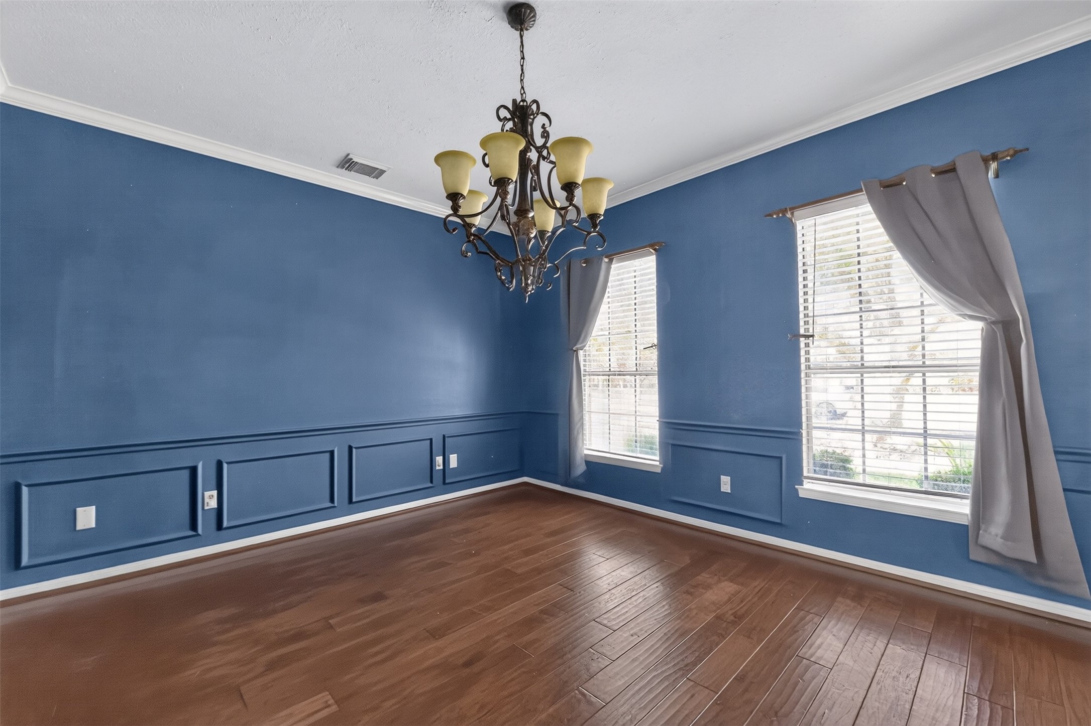 Chair rail and crown molding add a touch of sophistication to the formal dining room.