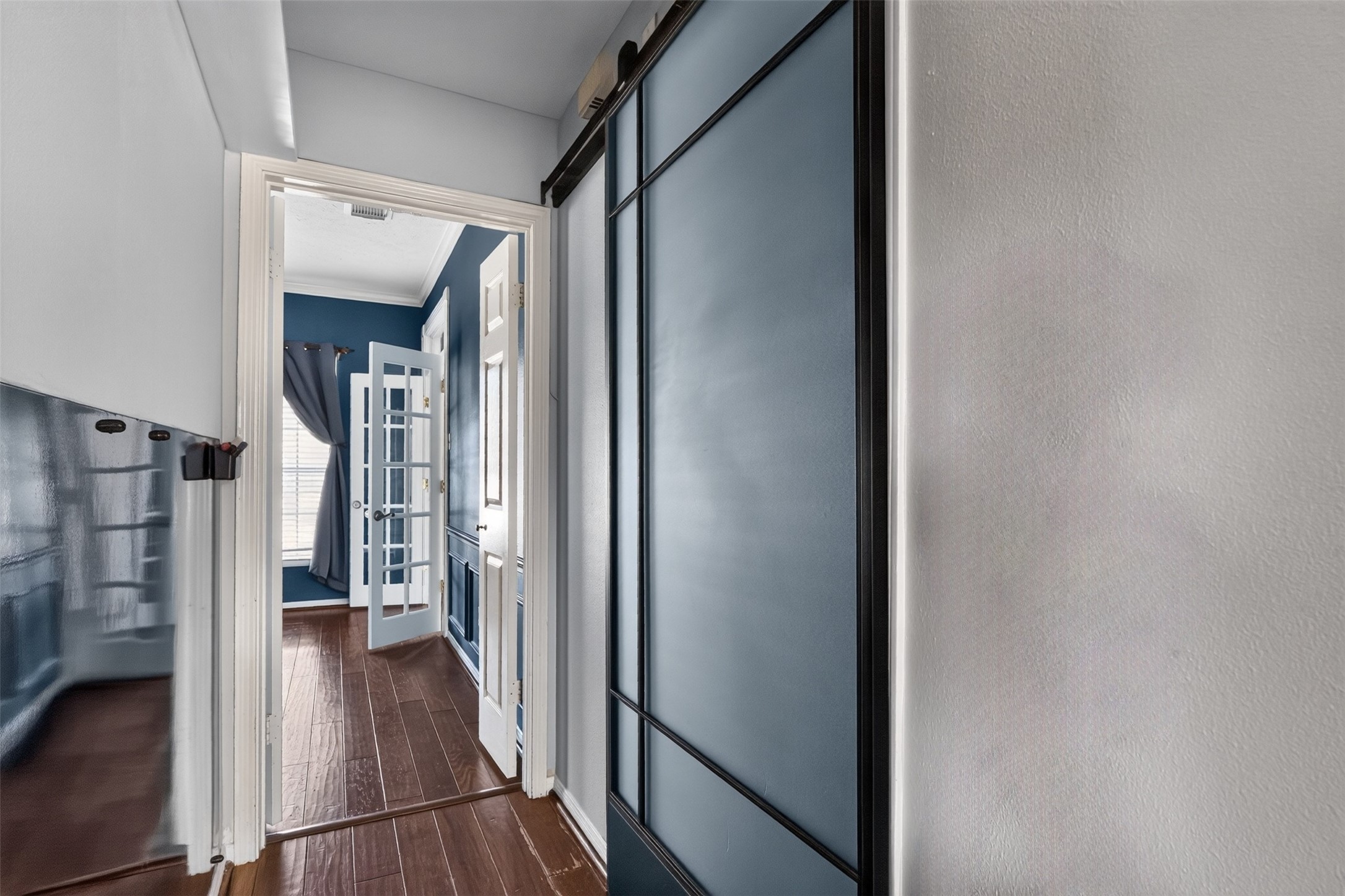 The kitchen leads back to the formal dining room and has a half bath behind the sliding doors.