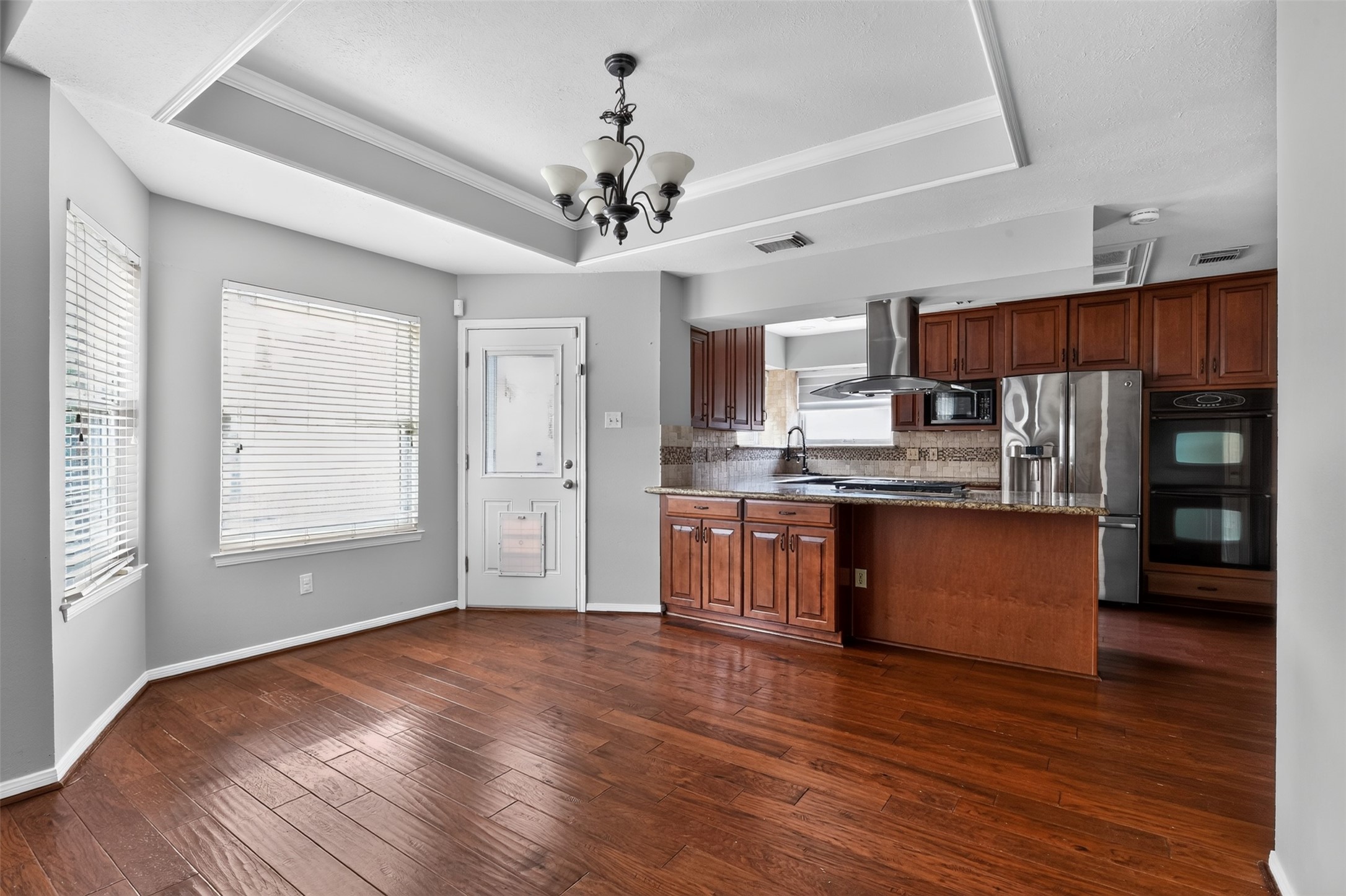 Breakfast area is filled with natural light with a view of the backyard.