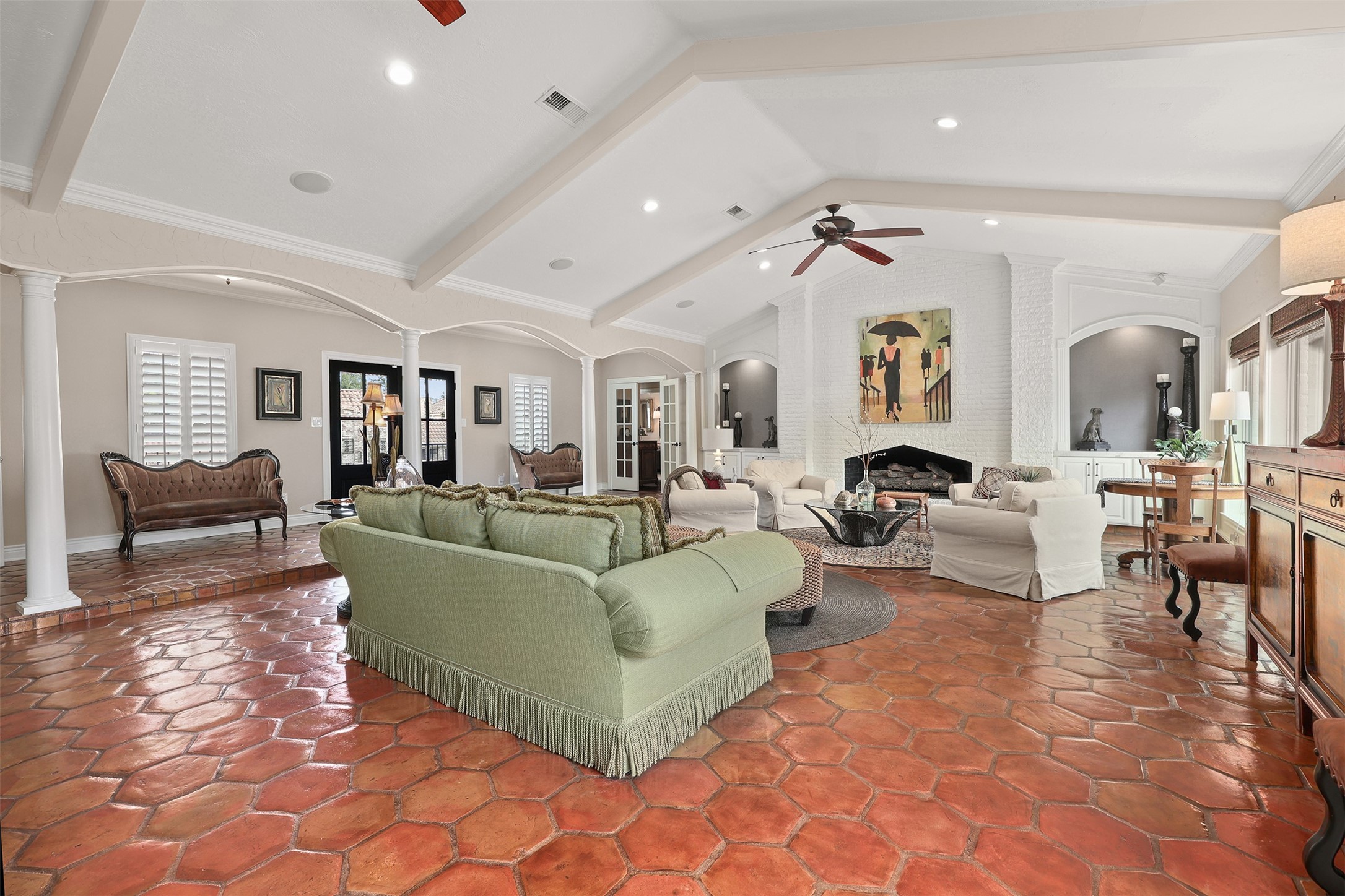 View from the kitchen and breakfast room overlooking the spacious main living area, with a hallway in the distance leading to the private bedroom wing.