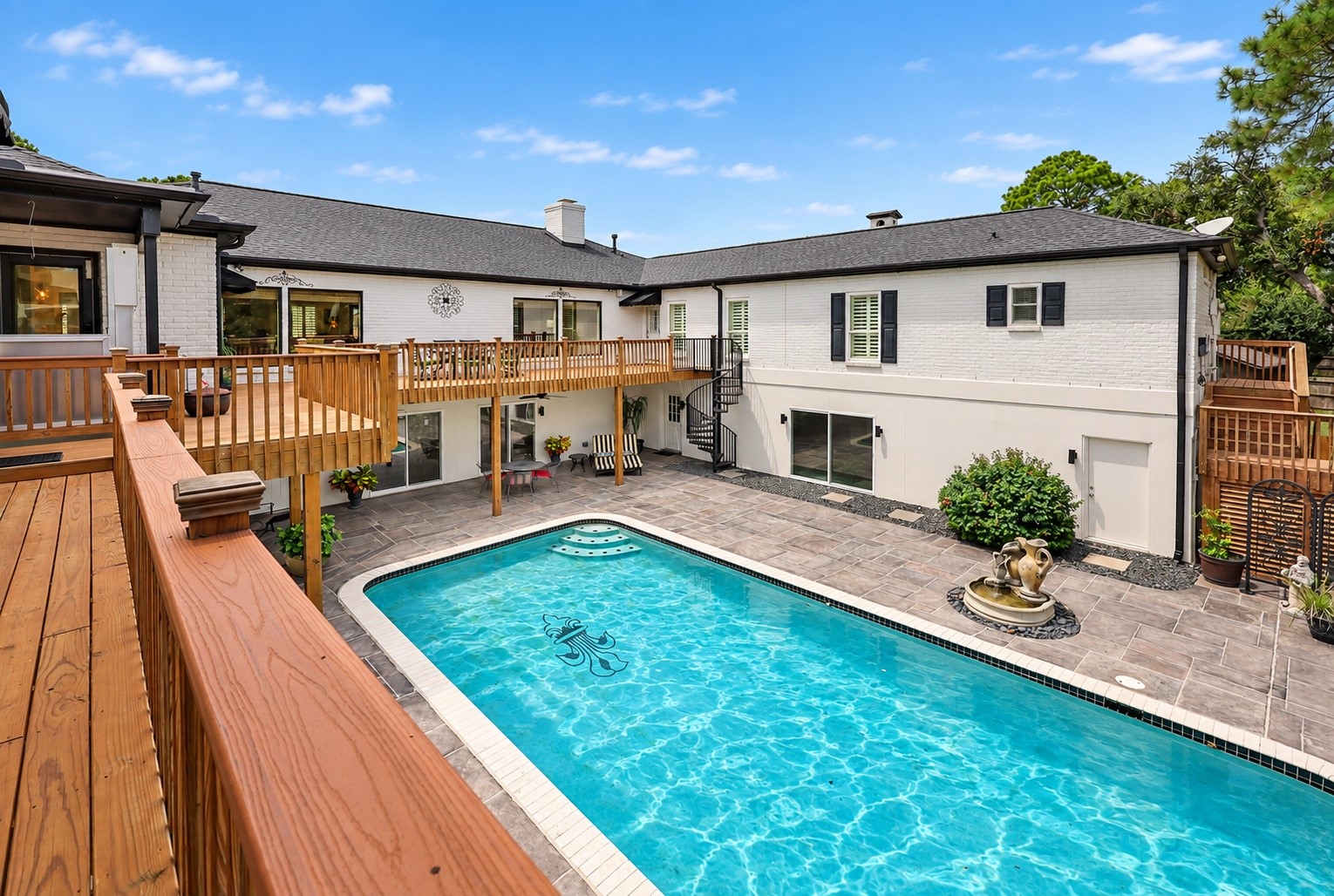 Another view of the beautiful pool area standing in front of the pool house.