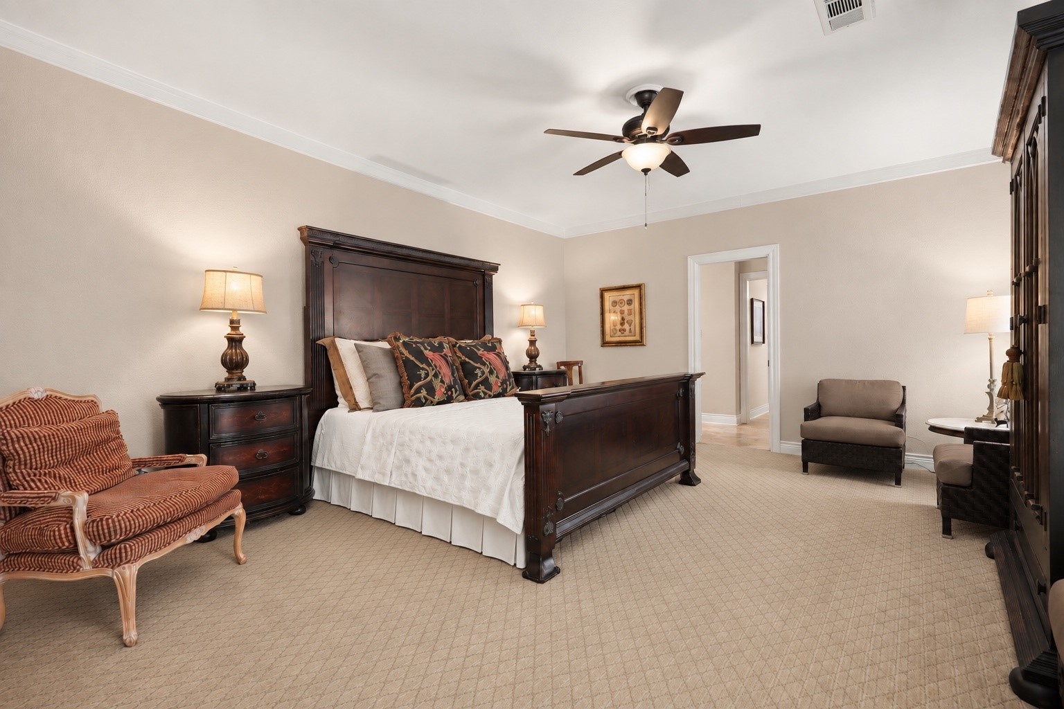 Spacious primary suite offers a relaxing retreat with high ceilings, elegant crown molding, and plenty of room for a comfortable sitting area. Three windows overlooking the beautiful pool bring in natural light and lovely views, creating a warm and inviting private sanctuary.