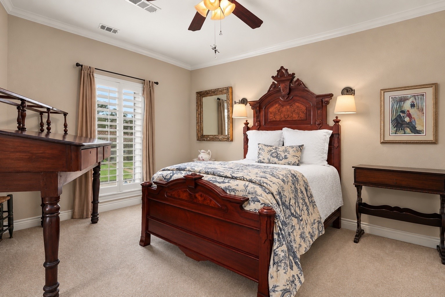 Bedroom one features a large front-facing casement window that opens outward, filling the room with natural light. A convenient pocket door provides direct access to a full bathroom.