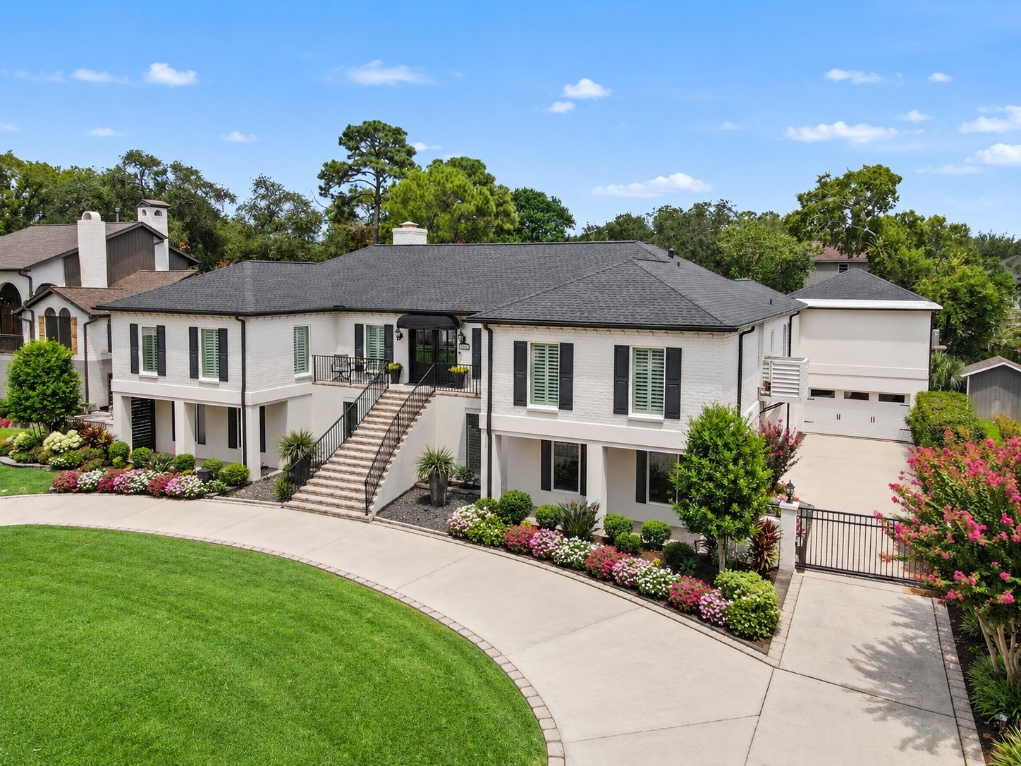 Beautifully maintained grounds with lush landscaping and a nine-zone sprinkler system. An electric driveway gate provides added privacy and convenient access to the expansive driveway, garae, and additional covered parking beneath the home. Thoughtfully designed for both beauty and functionality.