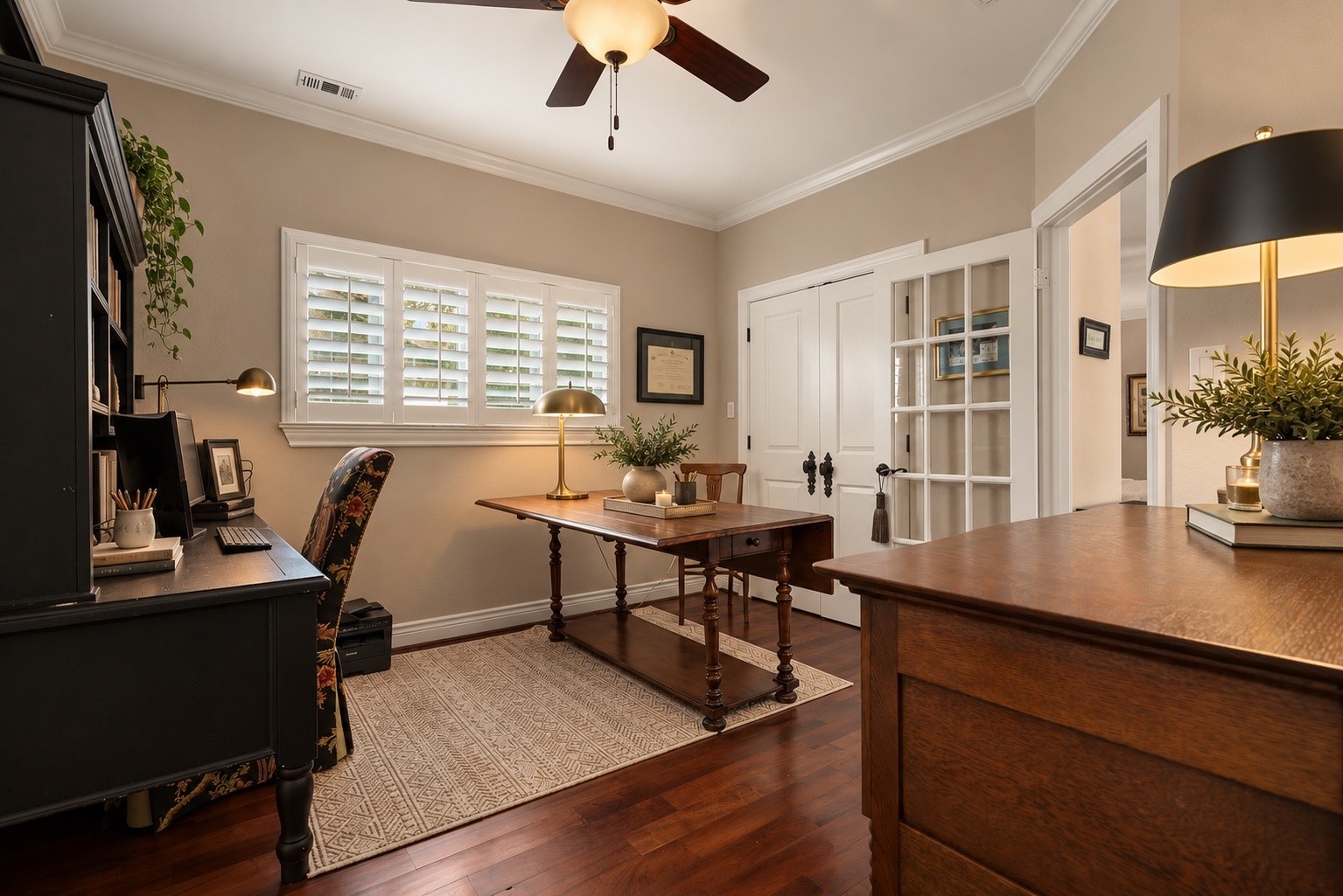 Bedroom #3, currently used as a home office, offers wonderful versatility with beautiful solid mesquite hardwood flooring sourced from Austin, plantation shutters, and elegant French doors. This spacious room shares a beautifully appointed bathroom with Bedroom #2 and can easily serve as a guest bedroom or private study.