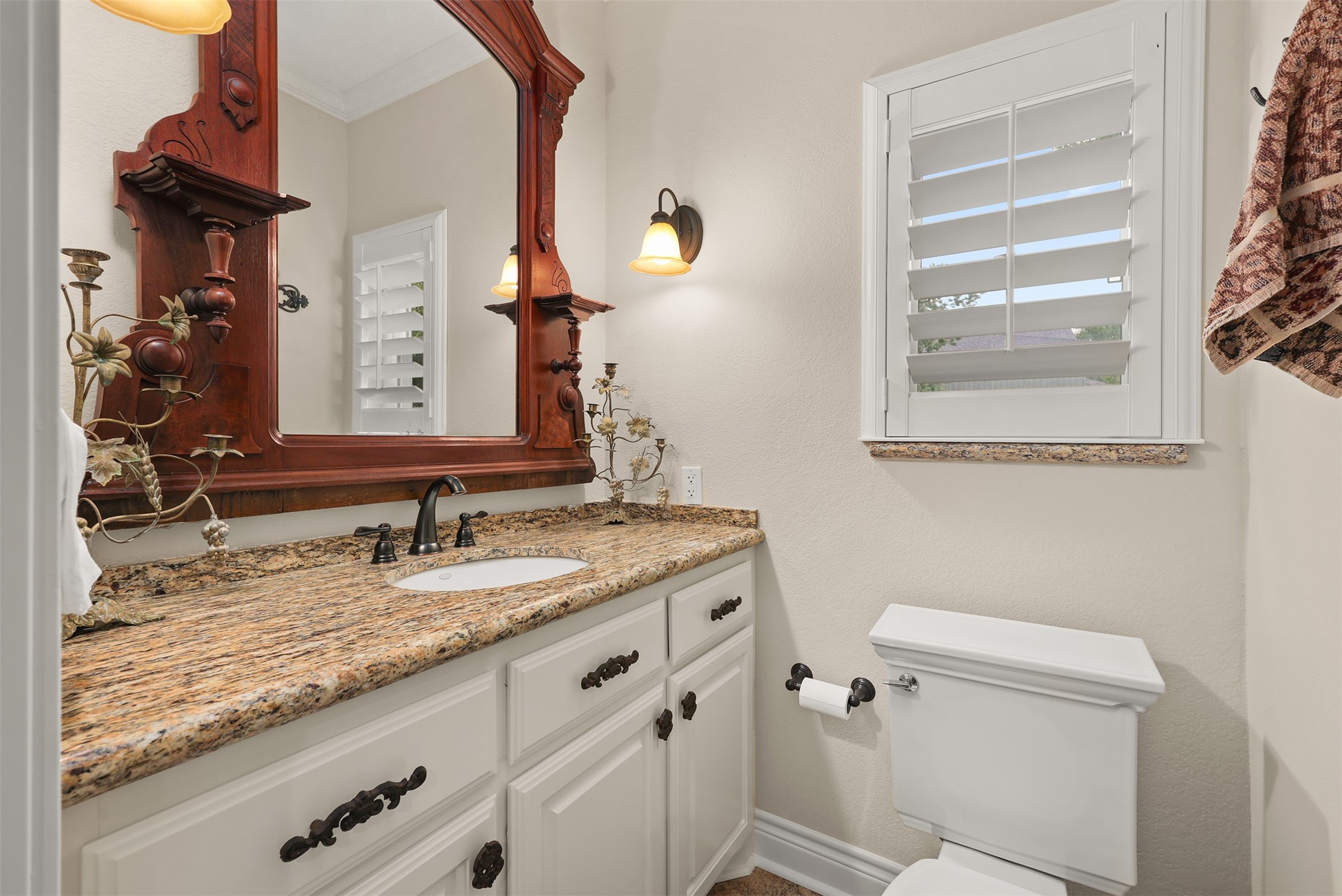Pool house features a private full bathroom with a spacious vanity and separate walk-in shower, offering comfort and convenience for guests or extending family. Please note: Decorative mirror above the vanity is excluded from the sale.