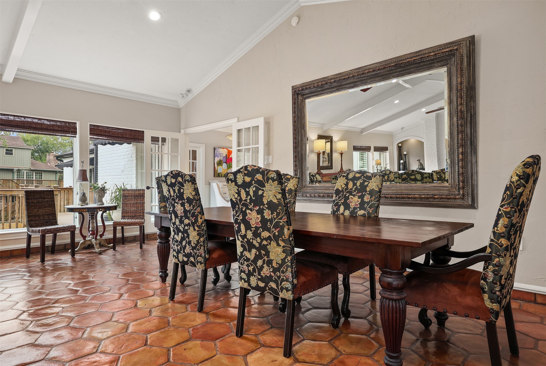 This spacious dining area is perfect for entertaining, featuring beautiful natural light and an impressive oversized decorative mirror that conveys with the home. Double French doors open to the breakfast room and kitchen, offering the flexibility of an open, inviting flow or added privacy while preparing meals and entertaining guests.