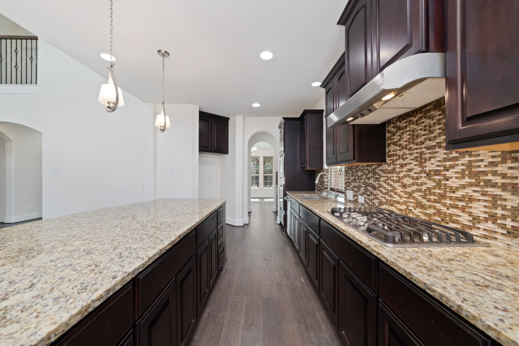 This modern kitchen boasts a spacious granite island, ideal for entertaining and creating memorable culinary experiences.