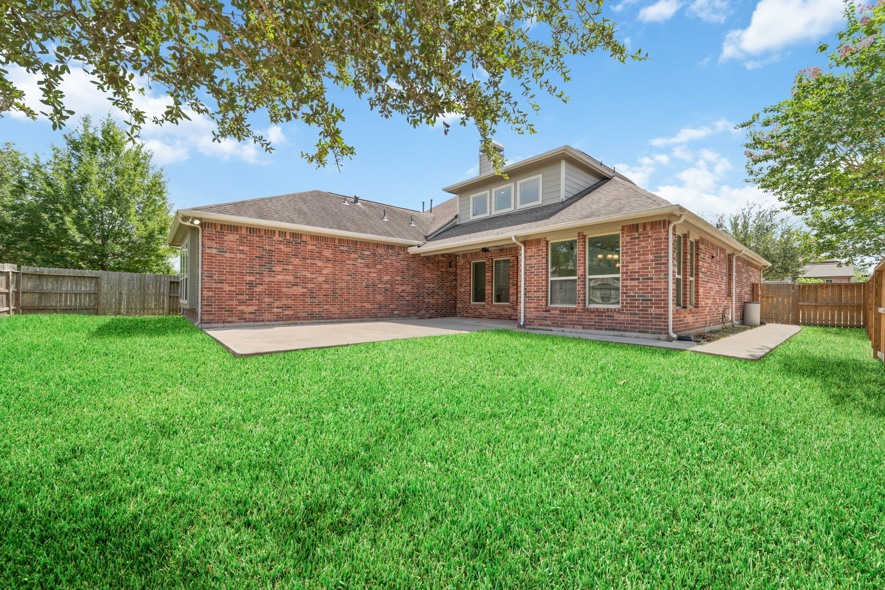 The expansive backyard is perfect for creating your own outdoor oasis, with plenty of room for a pool, outdoor kitchen, and entertaining.