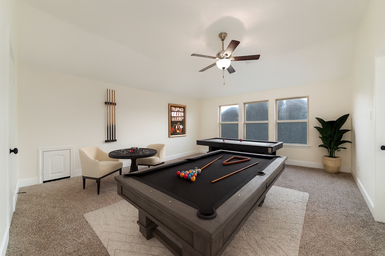 Upstairs, the spacious game room provides the perfect place for family gatherings, game nights, or simply relaxing together