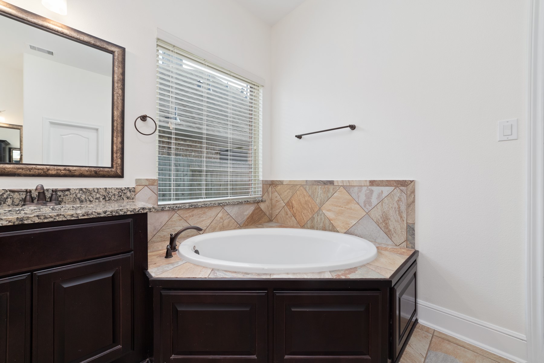 The primary bathroom features a garden tub, perfect for relaxing after a long day.