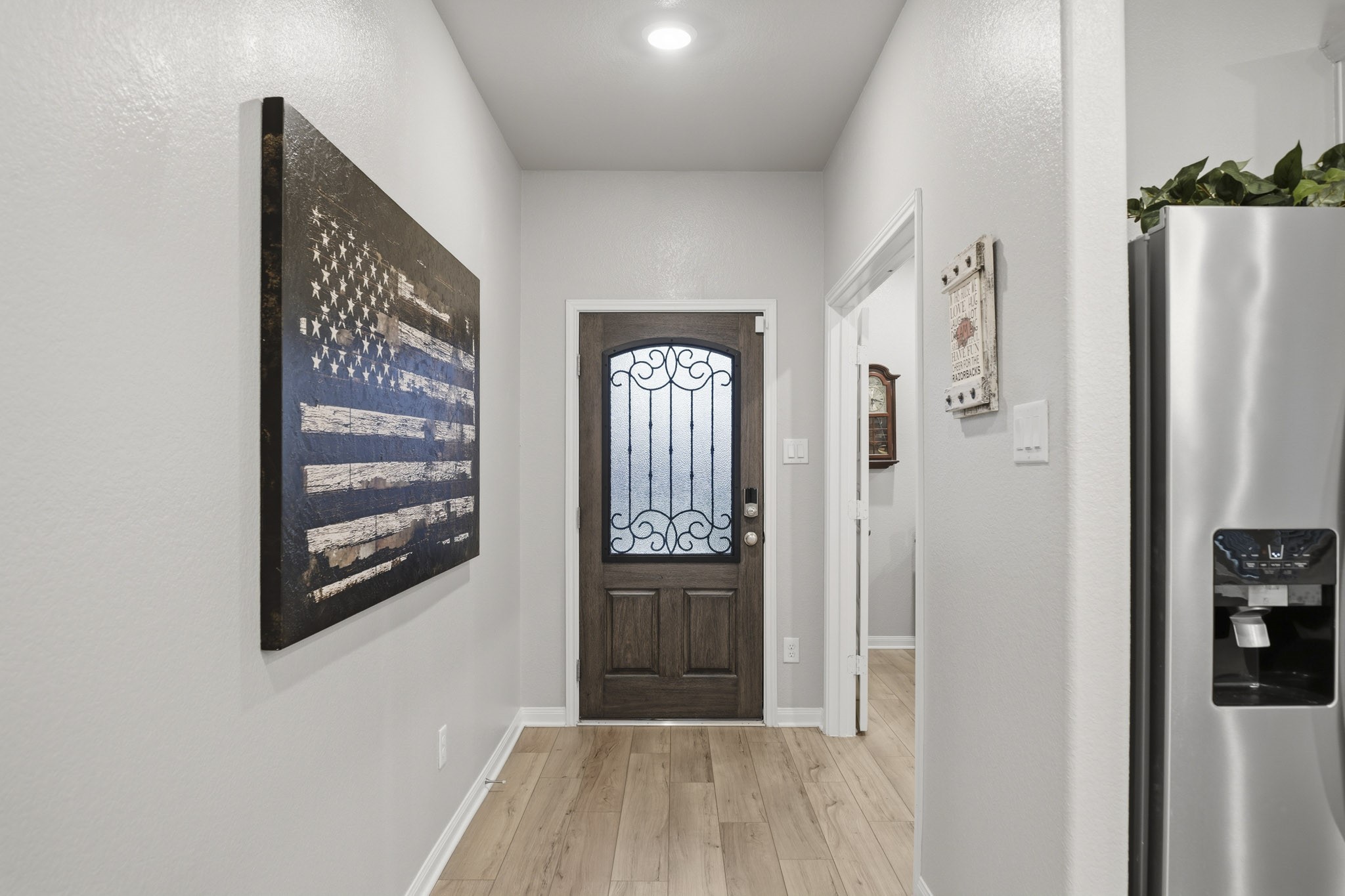 Charming entryway with a decorative glass front door.