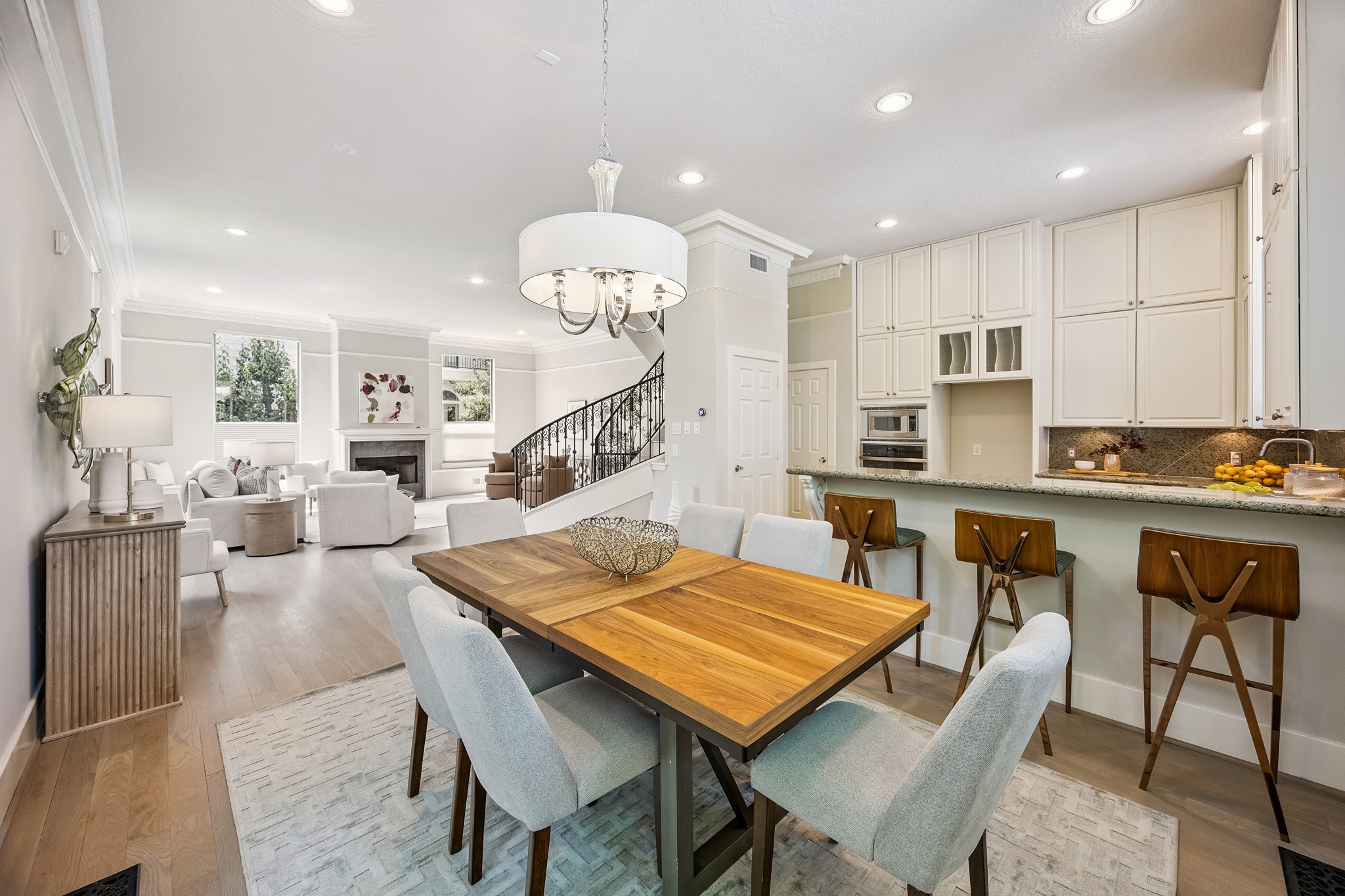 Open dining area with additional breakfast bar seating and seamless connection to the living room.