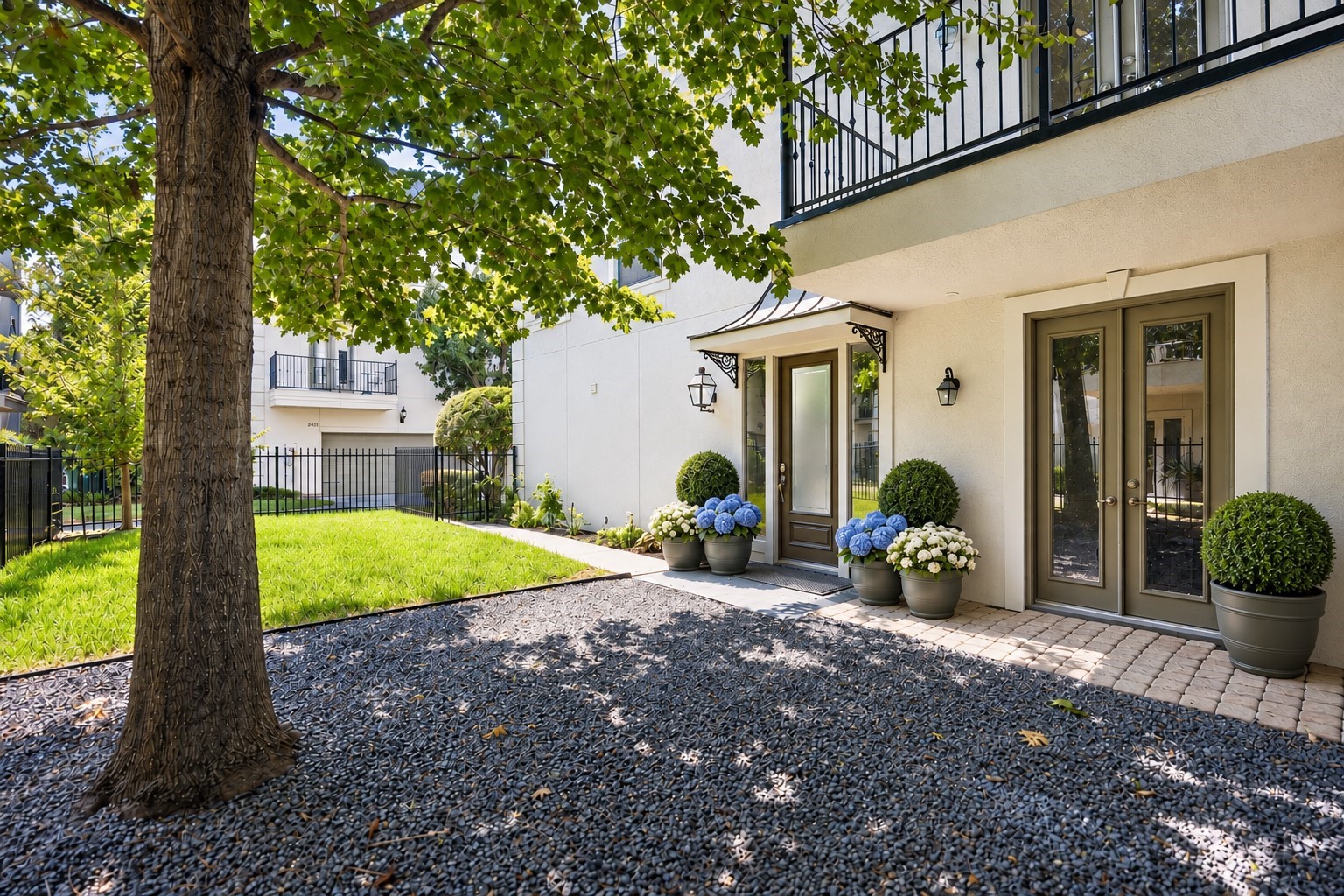 Desirable Hyde Park end-unit offering exceptional privacy, wonderful natural light and a rare private grass yard shaded by established landscapingall within a gated community.