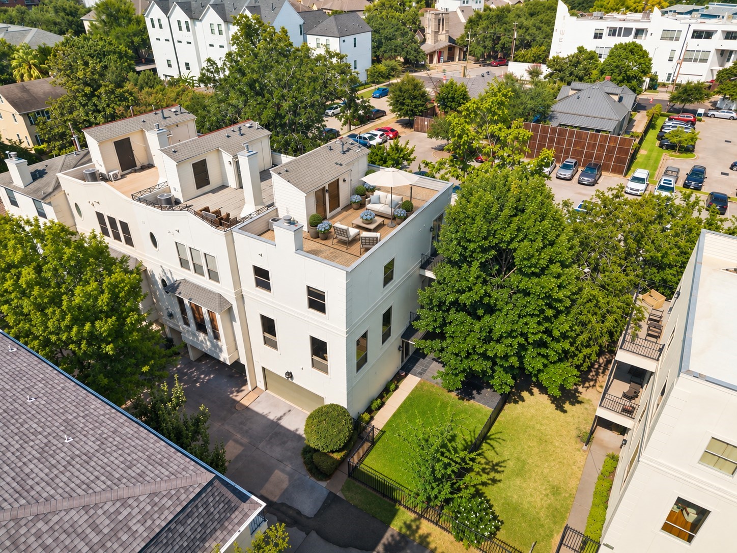 Aerial view highlights the end-unit setting, rare private fenced grass yard and expansive rooftop terrace, offering multiple outdoor spaces in the heart of Hyde Park. *Image has been virtually staged.