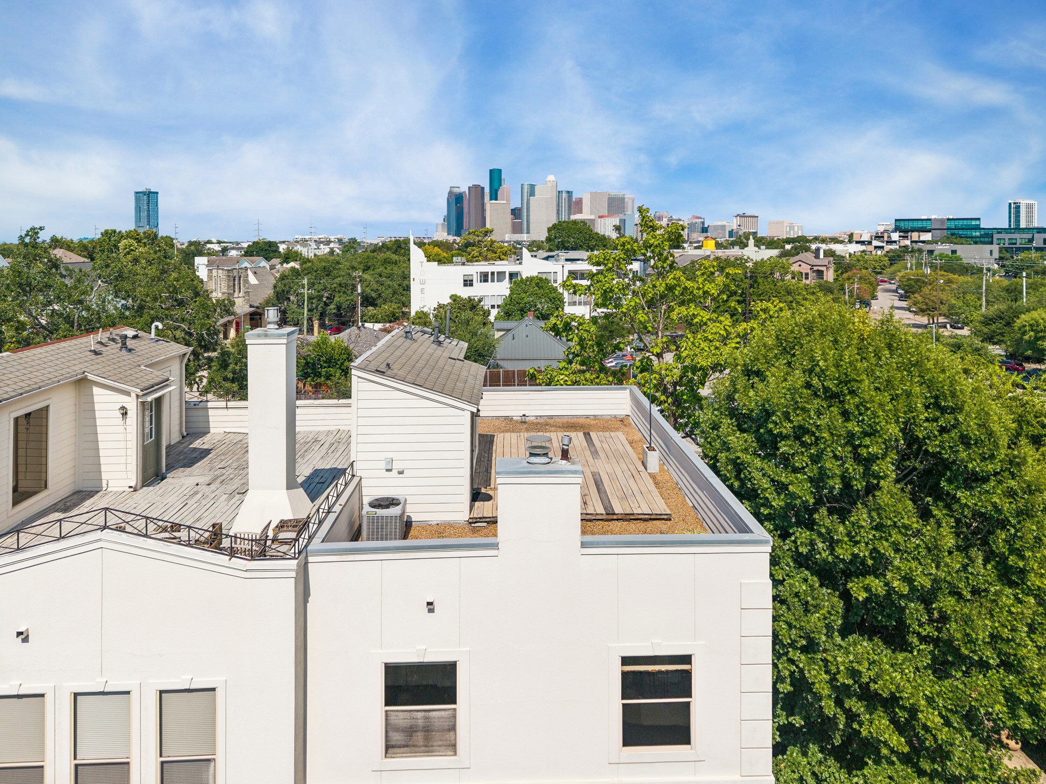 Elevated perspective showcasing the homes rooftop terrace and proximity to Downtown Houston.